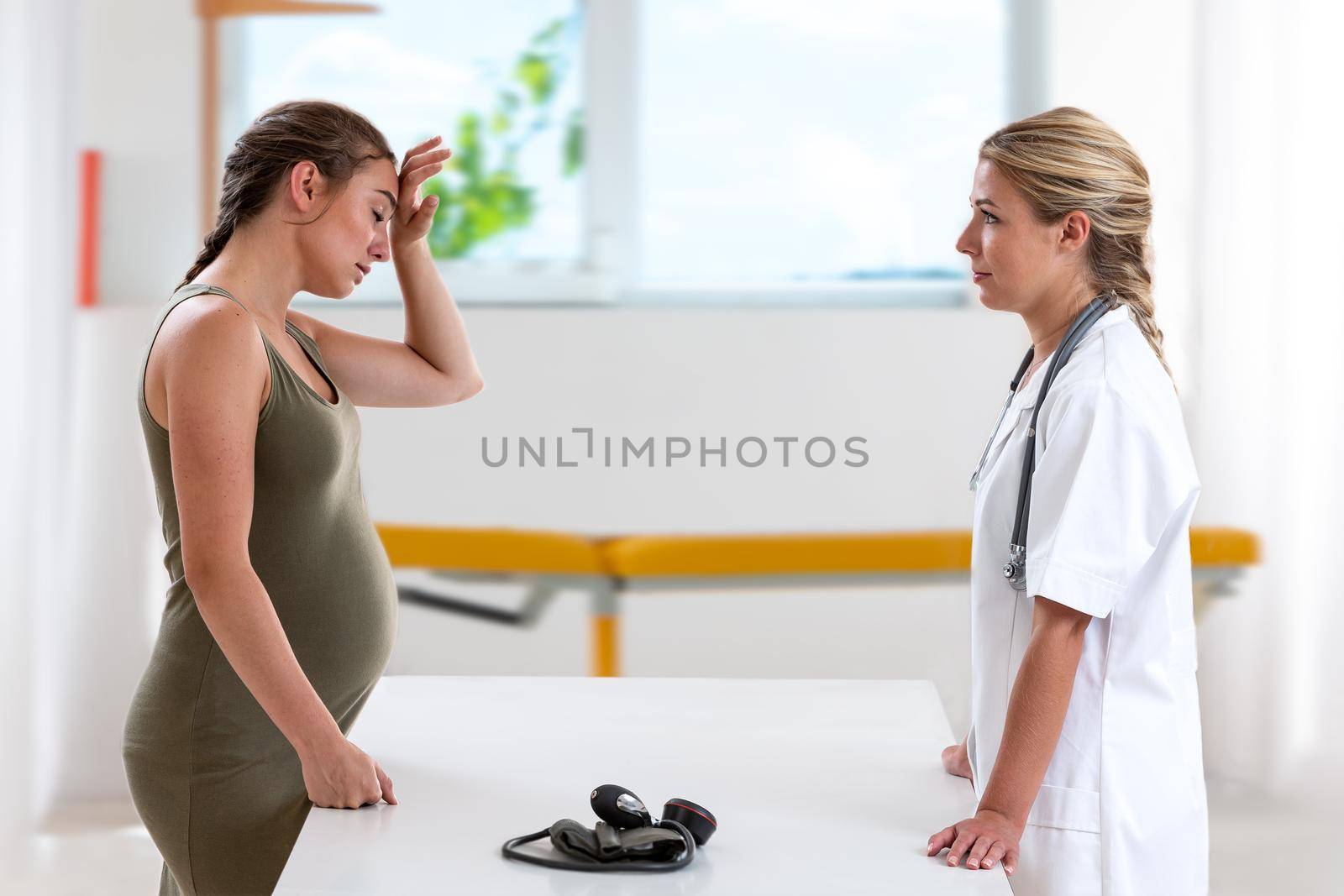 Woman 7 months pregnant in consultation by JPC-PROD