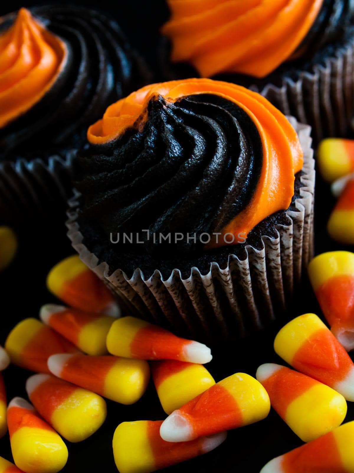 Halloween cupcakes decorated with black and orange swirled icing.