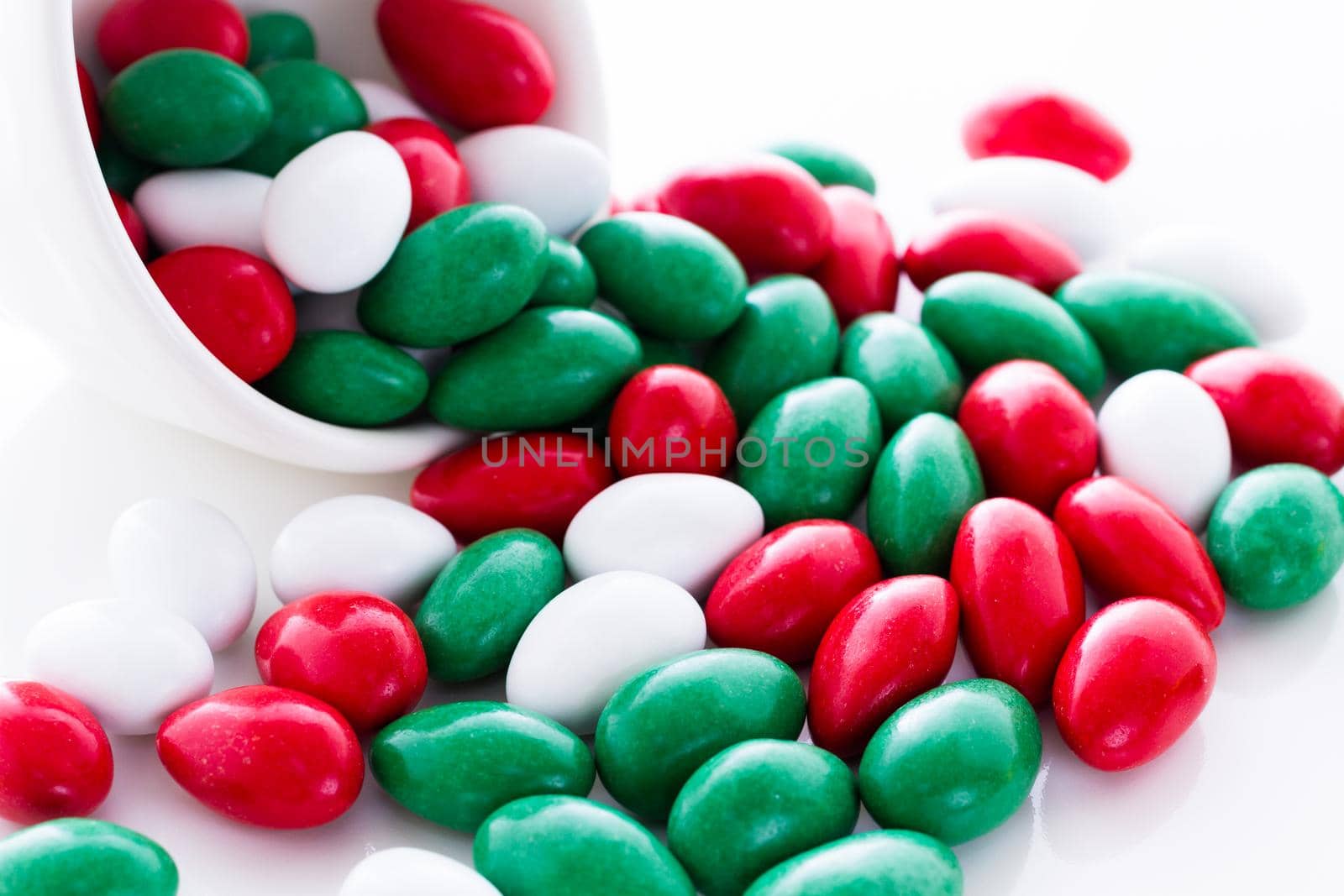 Colorful red, green and white candies on white background.