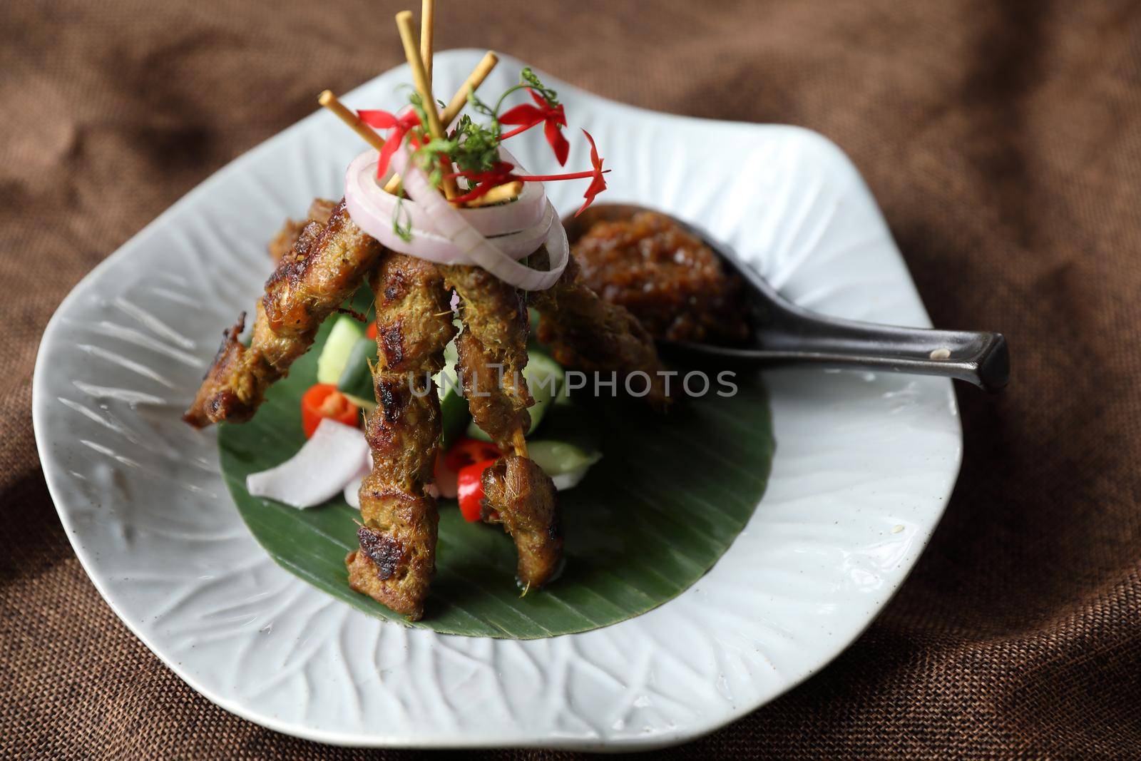 Chicken Satay on dark brown table street food appetizer by piyato