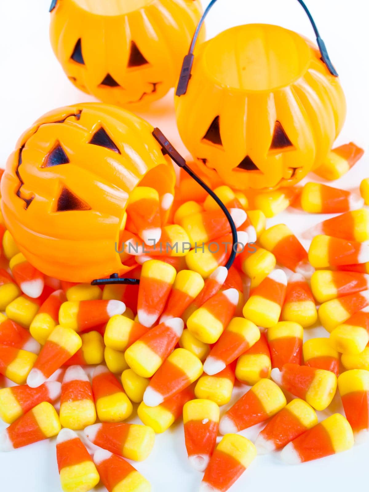 Candy corn candies falling out of Halloween treat bag.