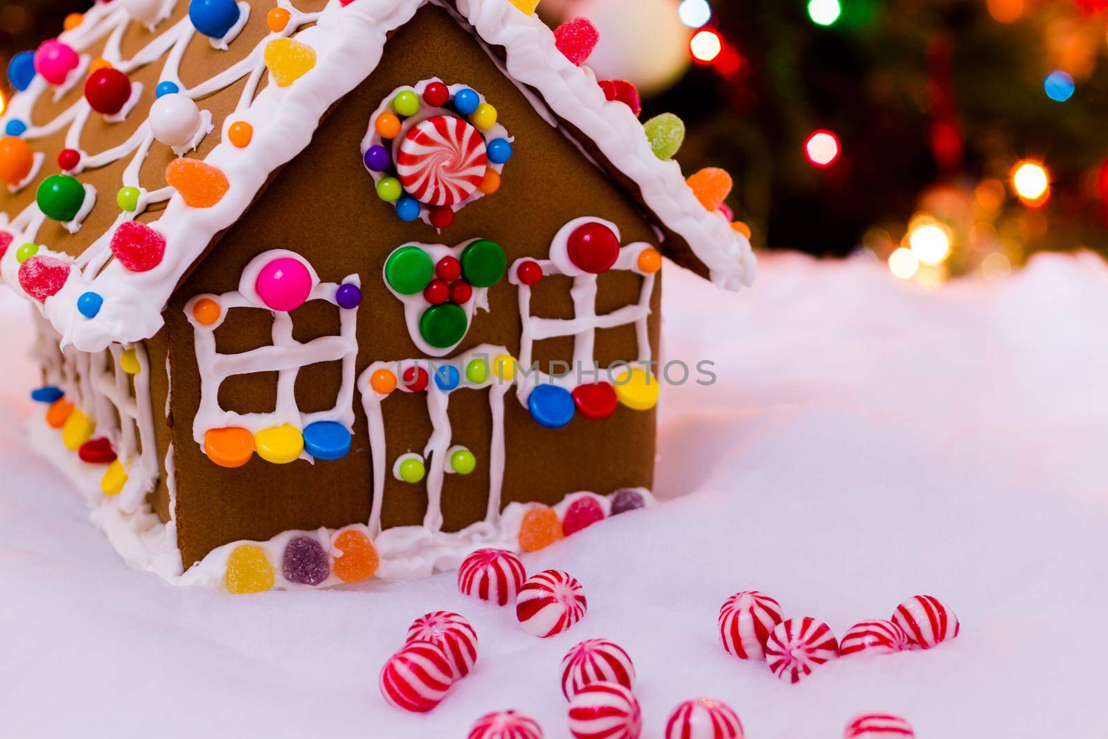 Gingerbread house with round peppermint candies.