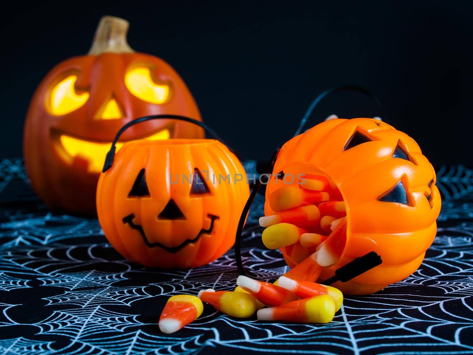 Candy corn candies falling out of Halloween treat bag.