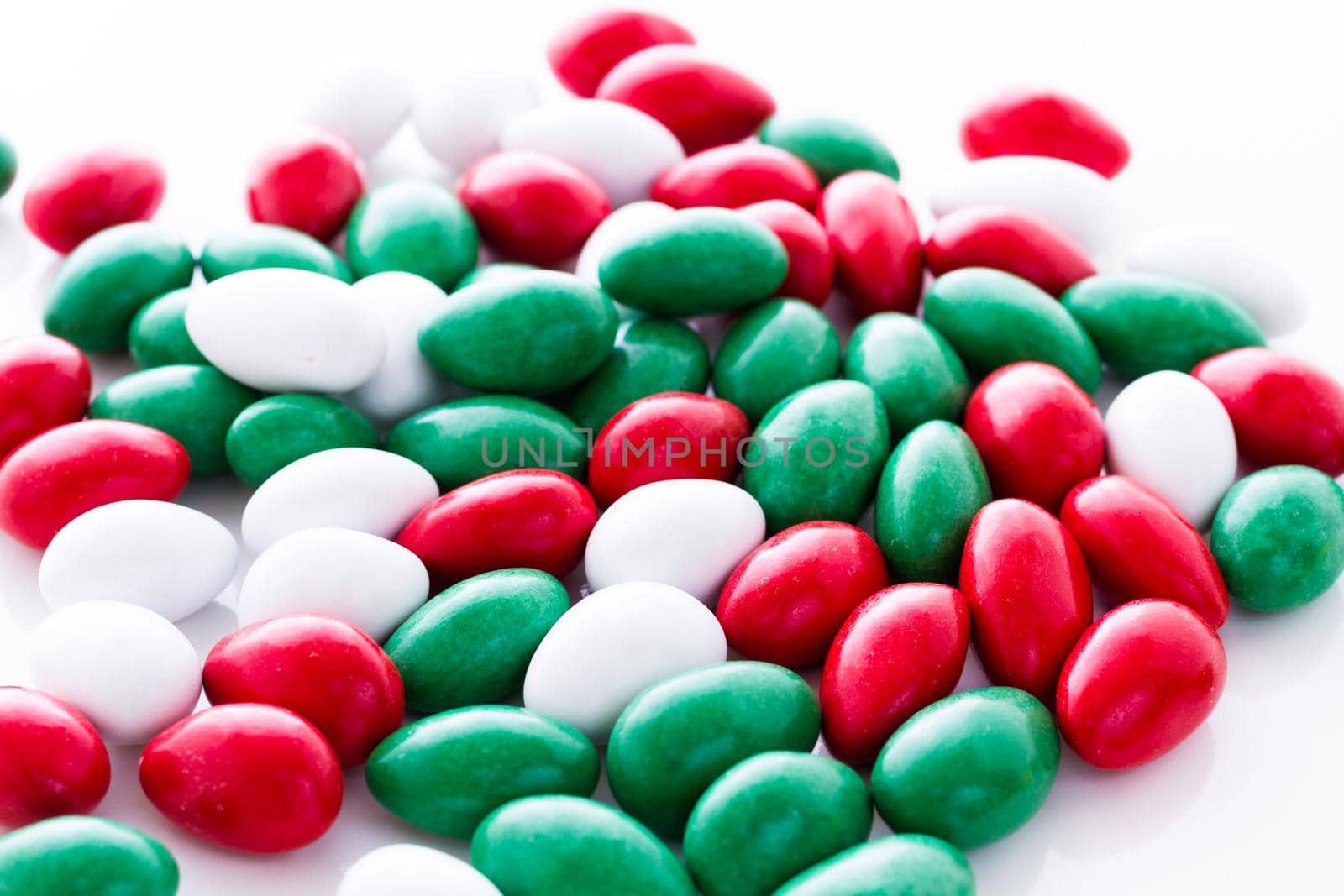 Colorful red, green and white candies on white background.
