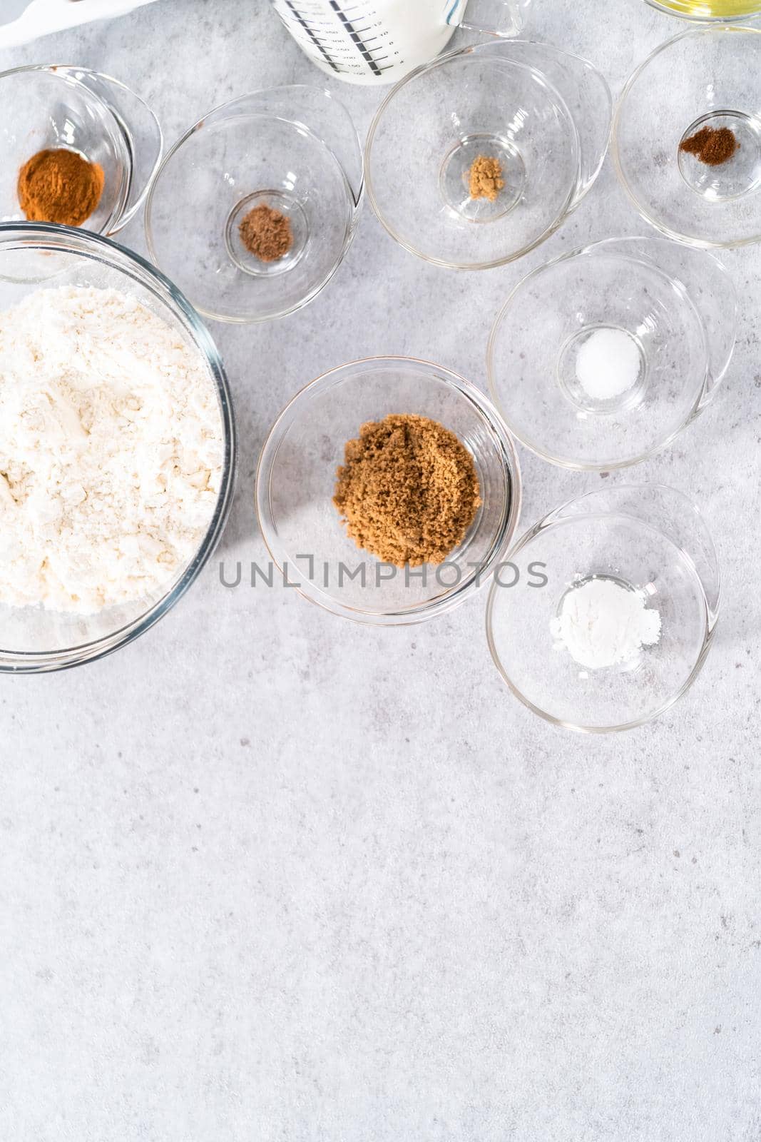 Ingredients in a glass mixing bowls to make pumpkin pancakes.