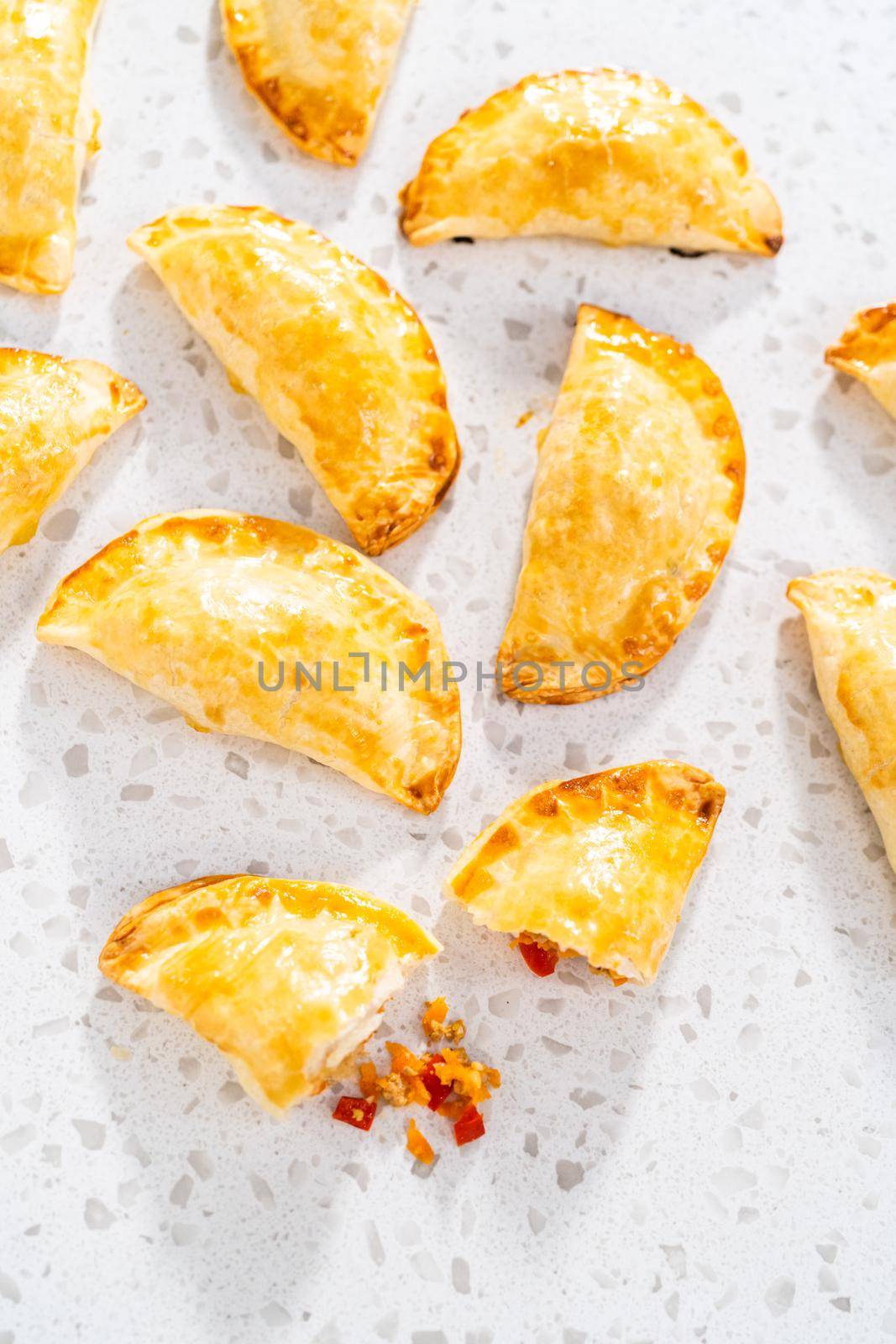 Freshly baked turkey empanadas on the kitchen counter.