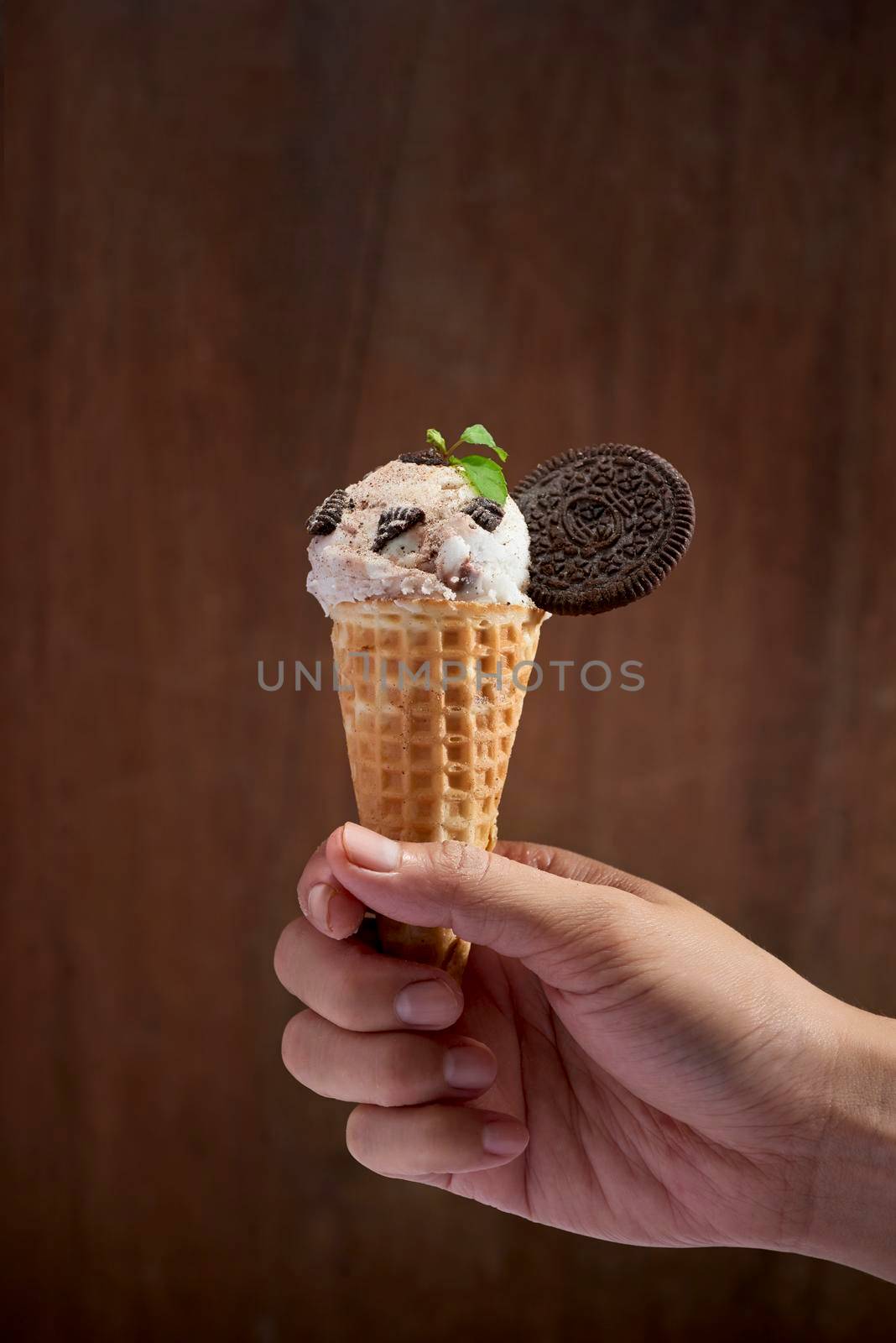 Sweet homemade ice cream with cookies in cone, selective focus by makidotvn