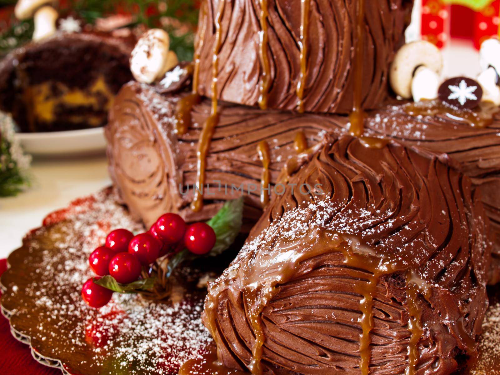 Traditional Christmas Yule Log cake decorated with marzipan mushrooms.