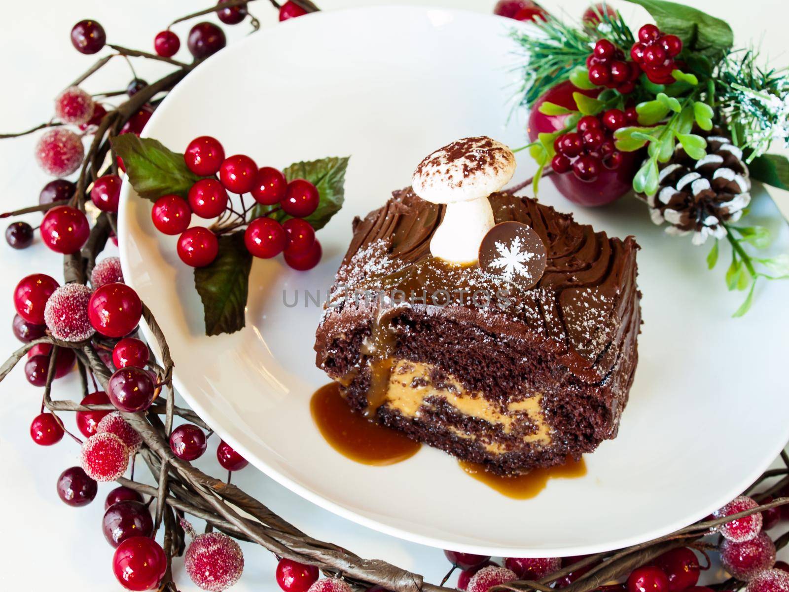 Traditional Christmas Yule Log cake decorated with marzipan mushrooms.
