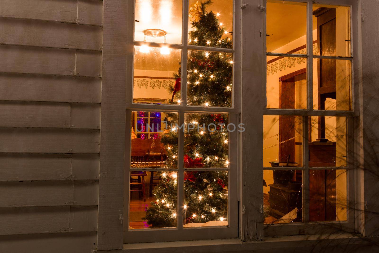 Historic farm decorated with Christmas lights.