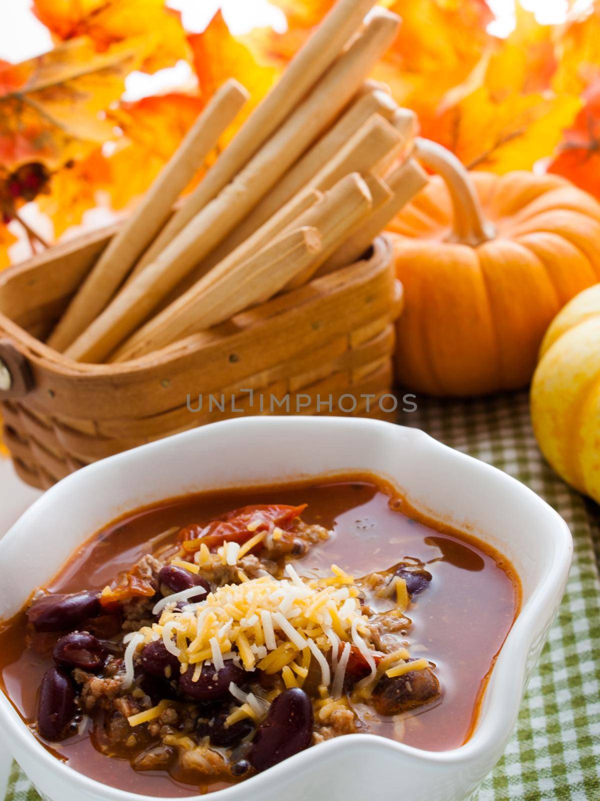 Homemade chili with ground turkey meat in white bowl.