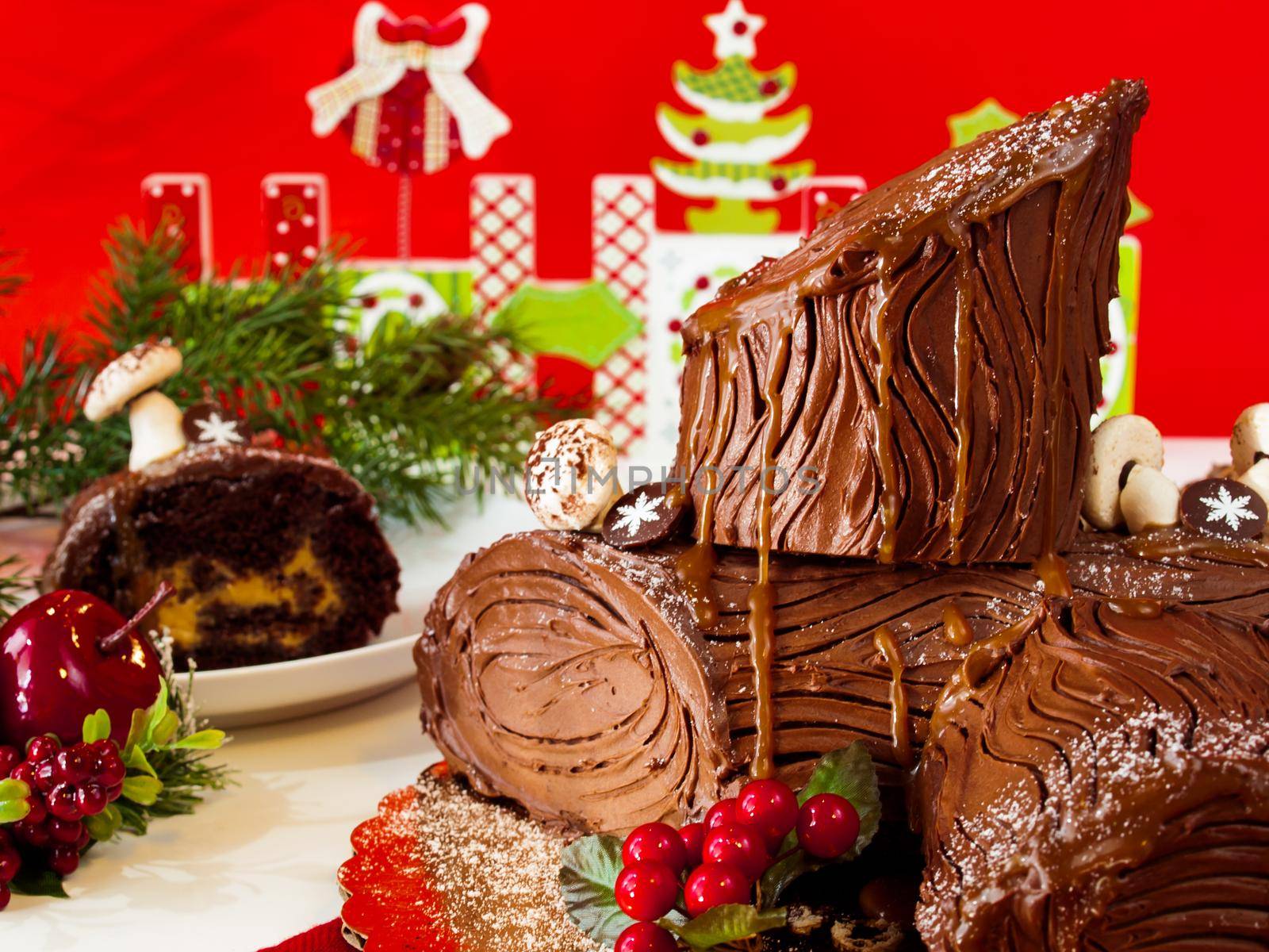 Traditional Christmas Yule Log cake decorated with marzipan mushrooms.