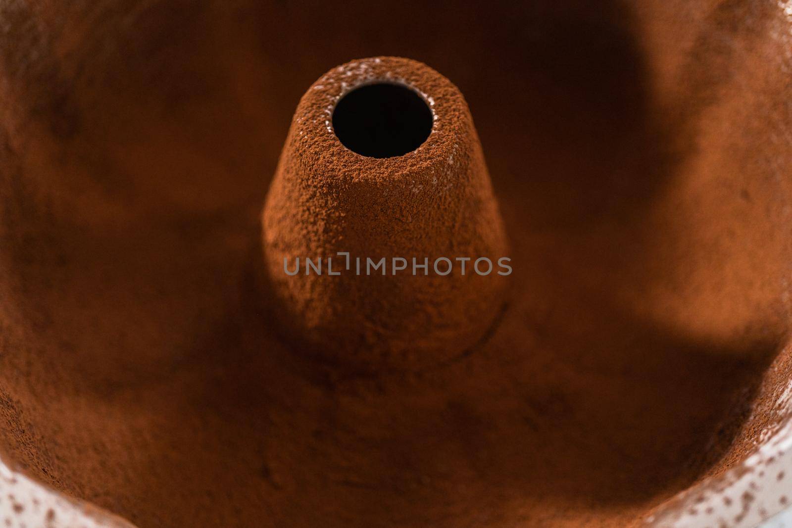 Greasing metal bundt cake pan to red velvet bundt cake with cream cheese glaze.