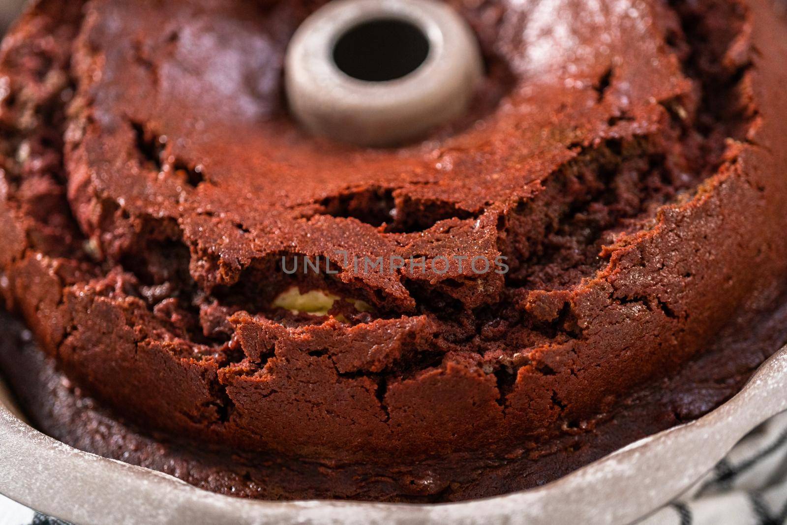 Cooling freshly baked red velvet bundt cake on a kitchen counter.
