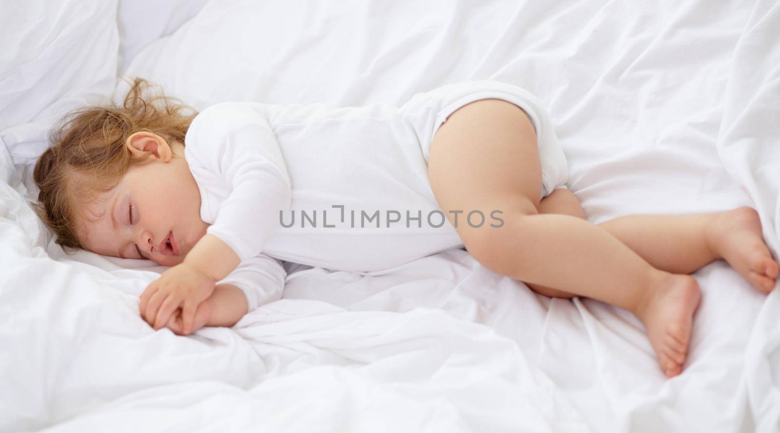 Babies need a lot of sleep. An adorable baby sleeping in the bedroom. by YuriArcurs
