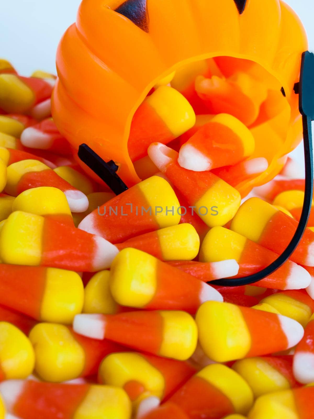 Candy corn candies falling out of Halloween treat bag.