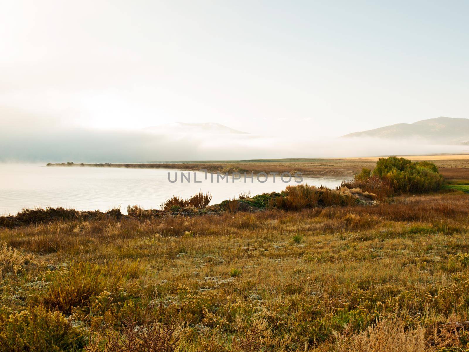 Early morning at the lake with fog in early Fall.