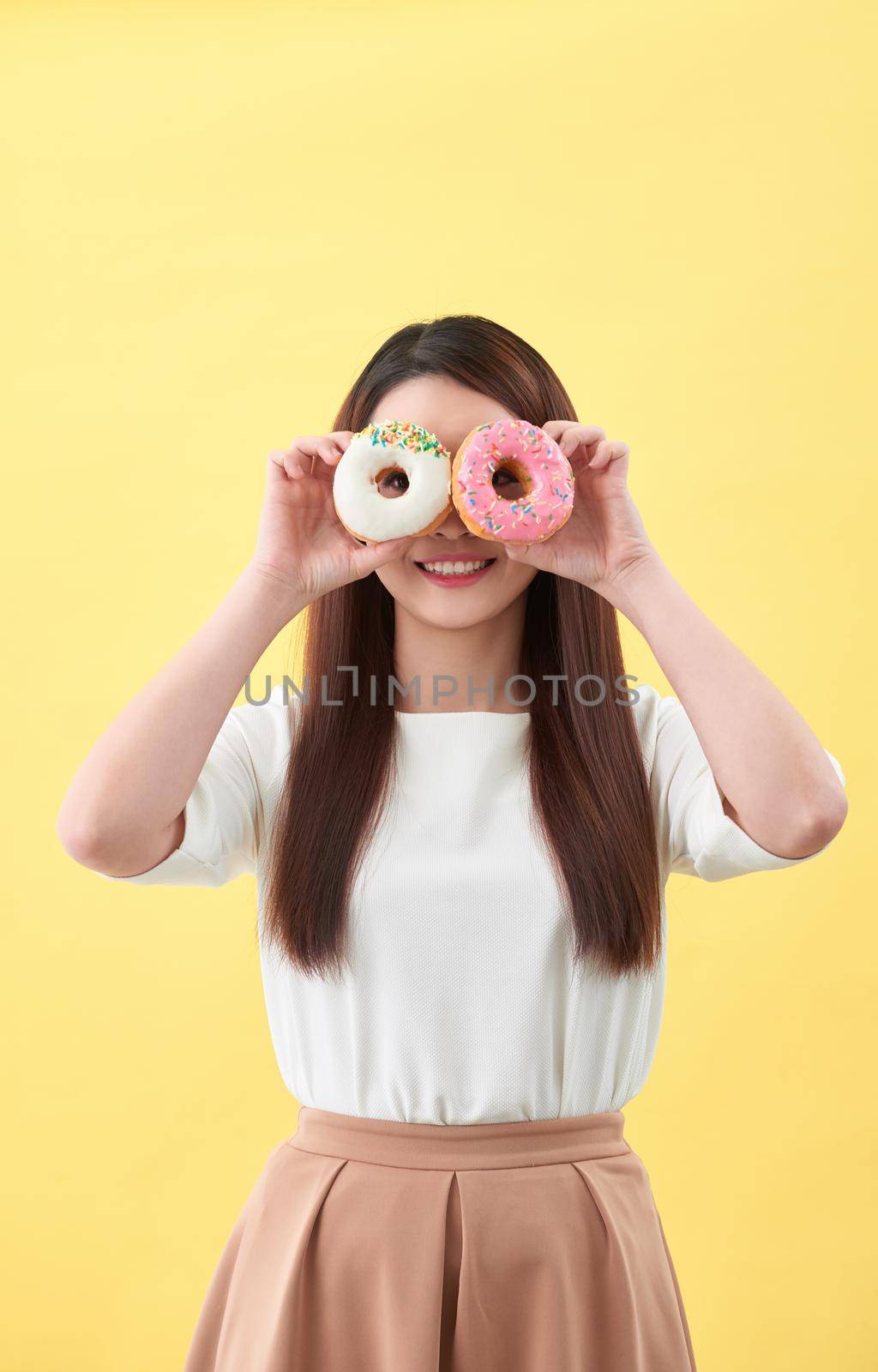 Beauty fashion model girl taking sweets and colorful donuts by makidotvn