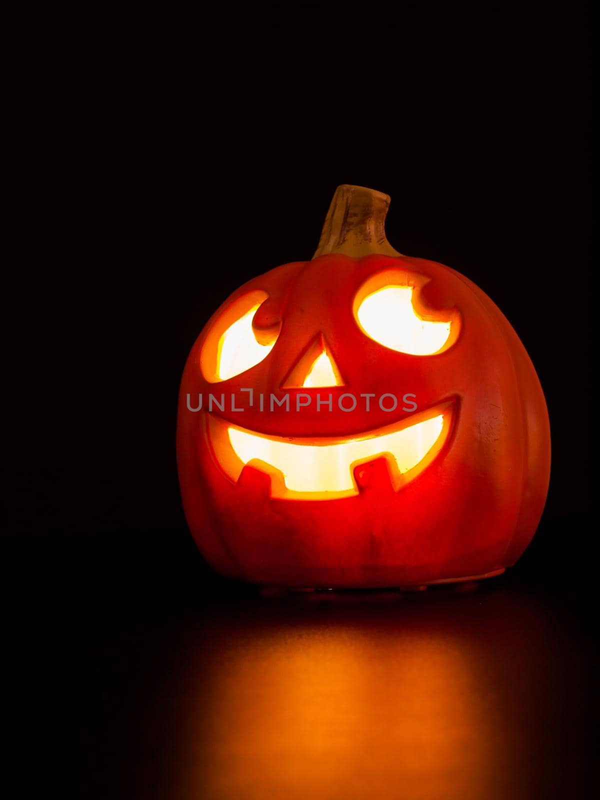 Lit jack-o'-lantern on black background.