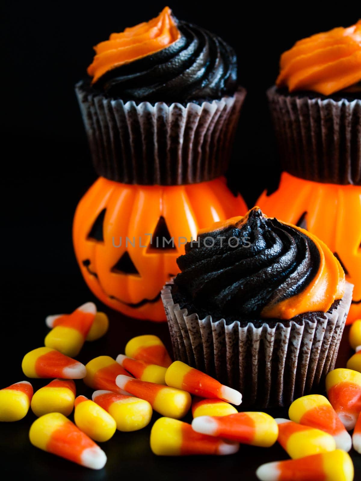 Halloween cupcakes decorated with black and orange swirled icing.