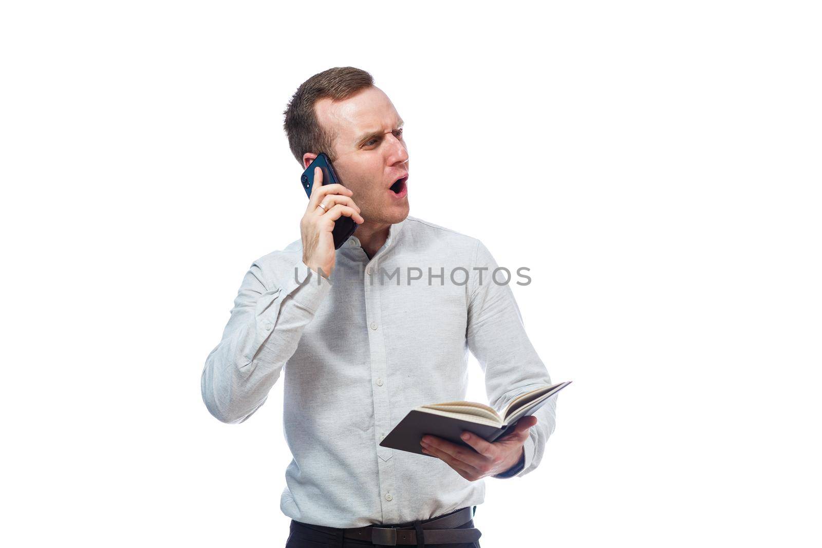 man businessman, teacher, mentor examines entries in your diary and talking on a cell phone. Isolated on white background