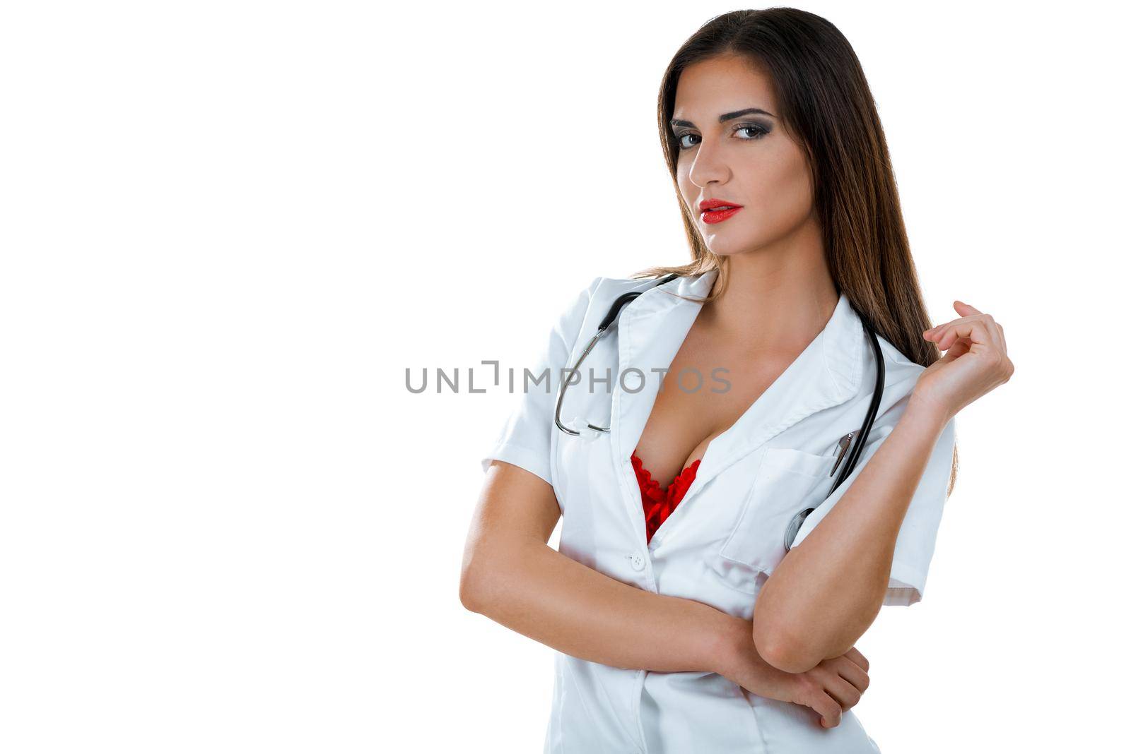 Beautiful sexy female doctor with stethoscope posing isolated on white background. Looking at camera.