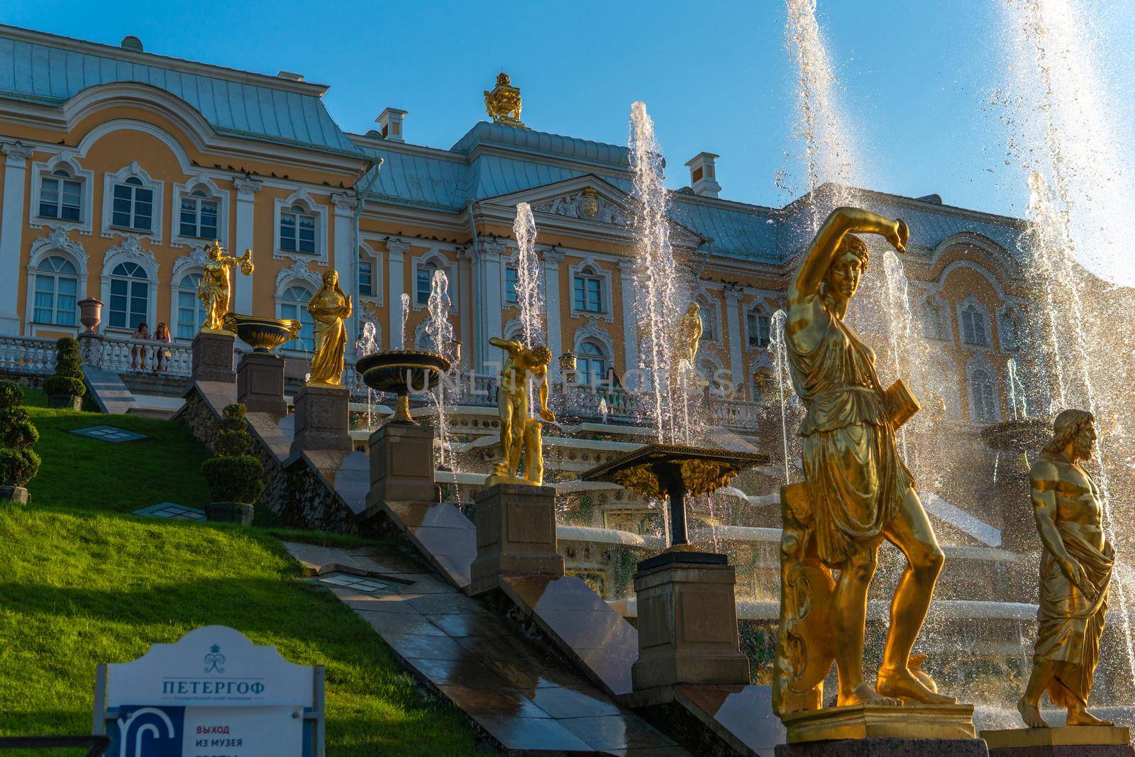 RUSSIA, PETERSBURG - AUG 19, 2022: fountain petersburg palace russia peterhof grand st cascade travel, for russian blue for gold and europe sky, summer cross. Unesco sight statue,