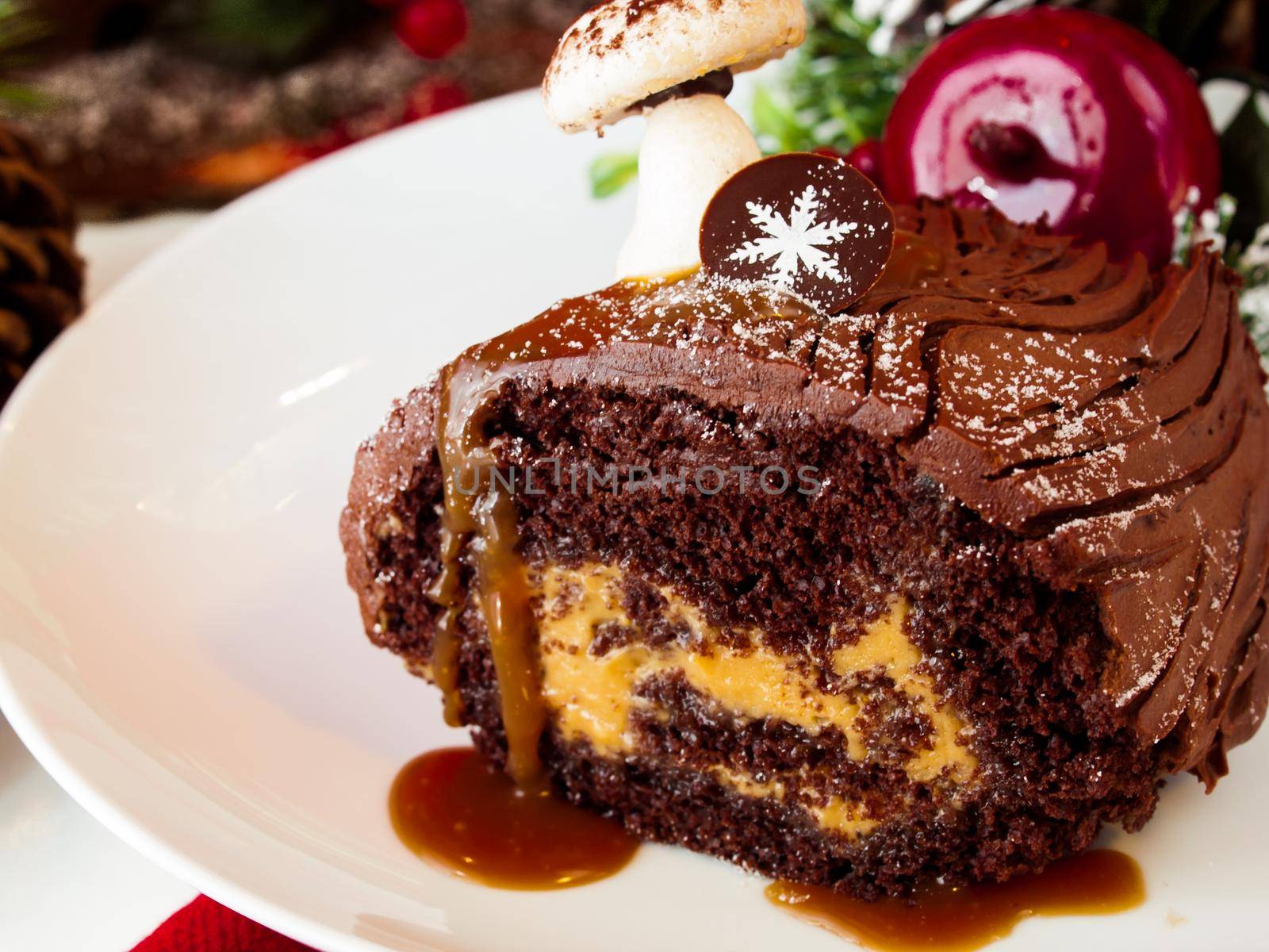 Traditional Christmas Yule Log cake decorated with marzipan mushrooms.