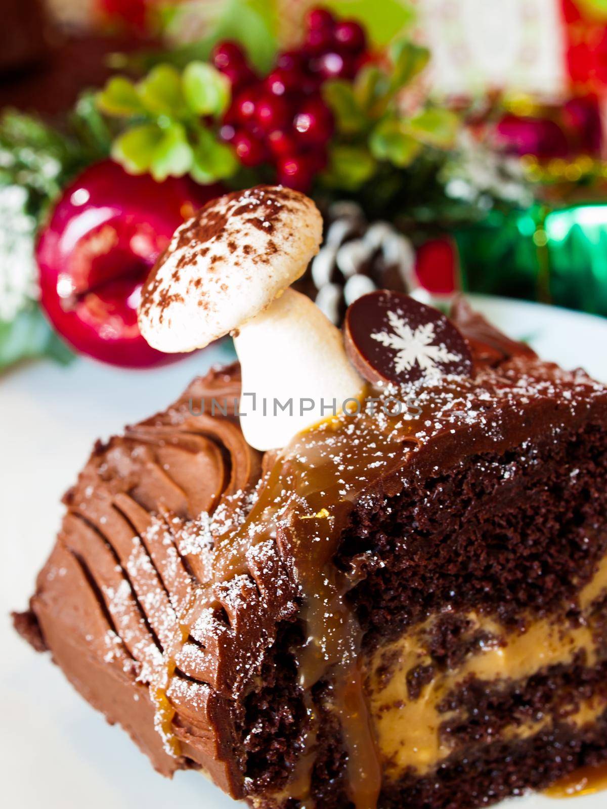 Traditional Christmas Yule Log cake decorated with marzipan mushrooms.