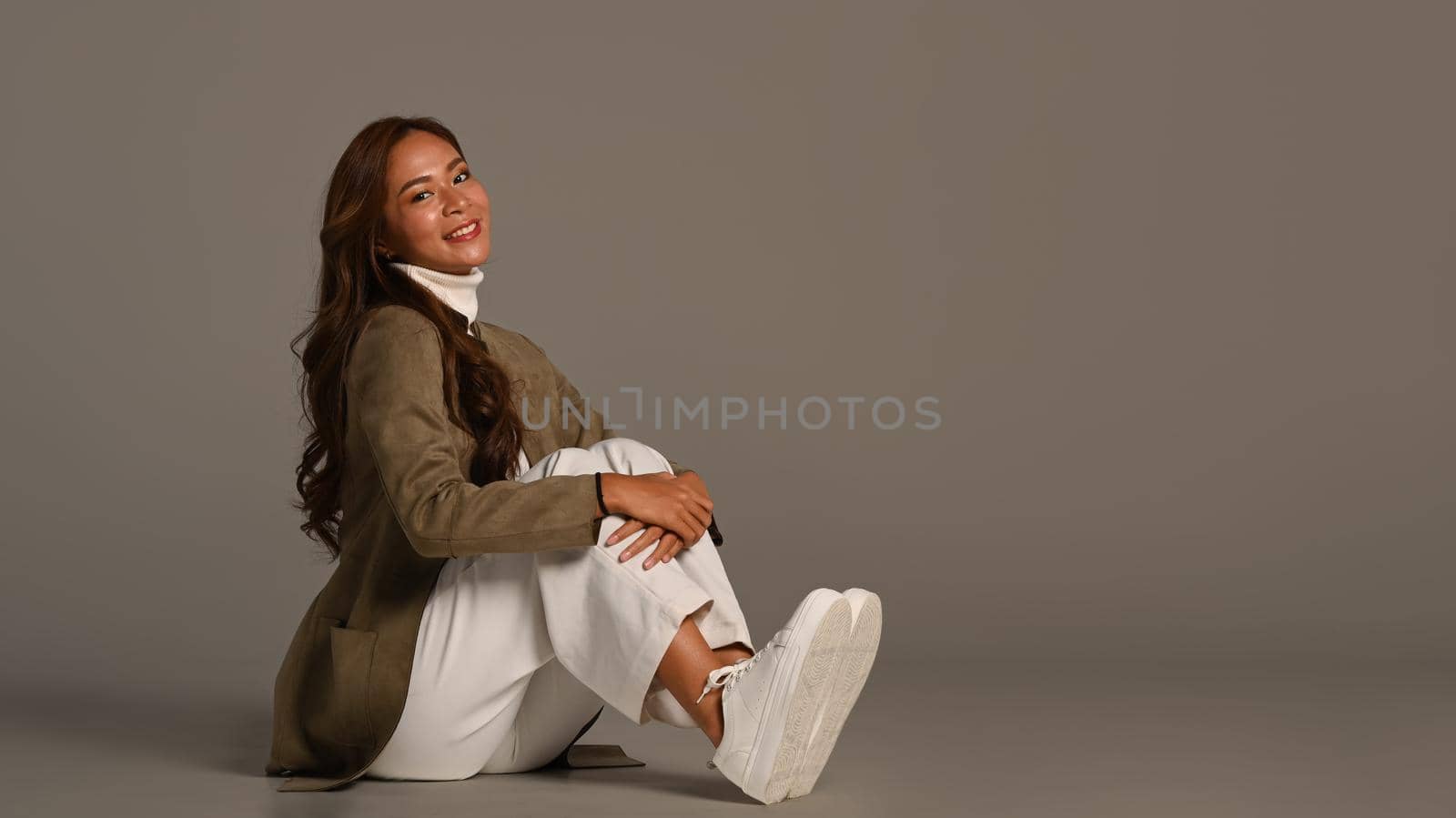 Elegant woman in stylish jacket posing isolated on grey background. Fashion studio photo, Autumn and Winter concept.