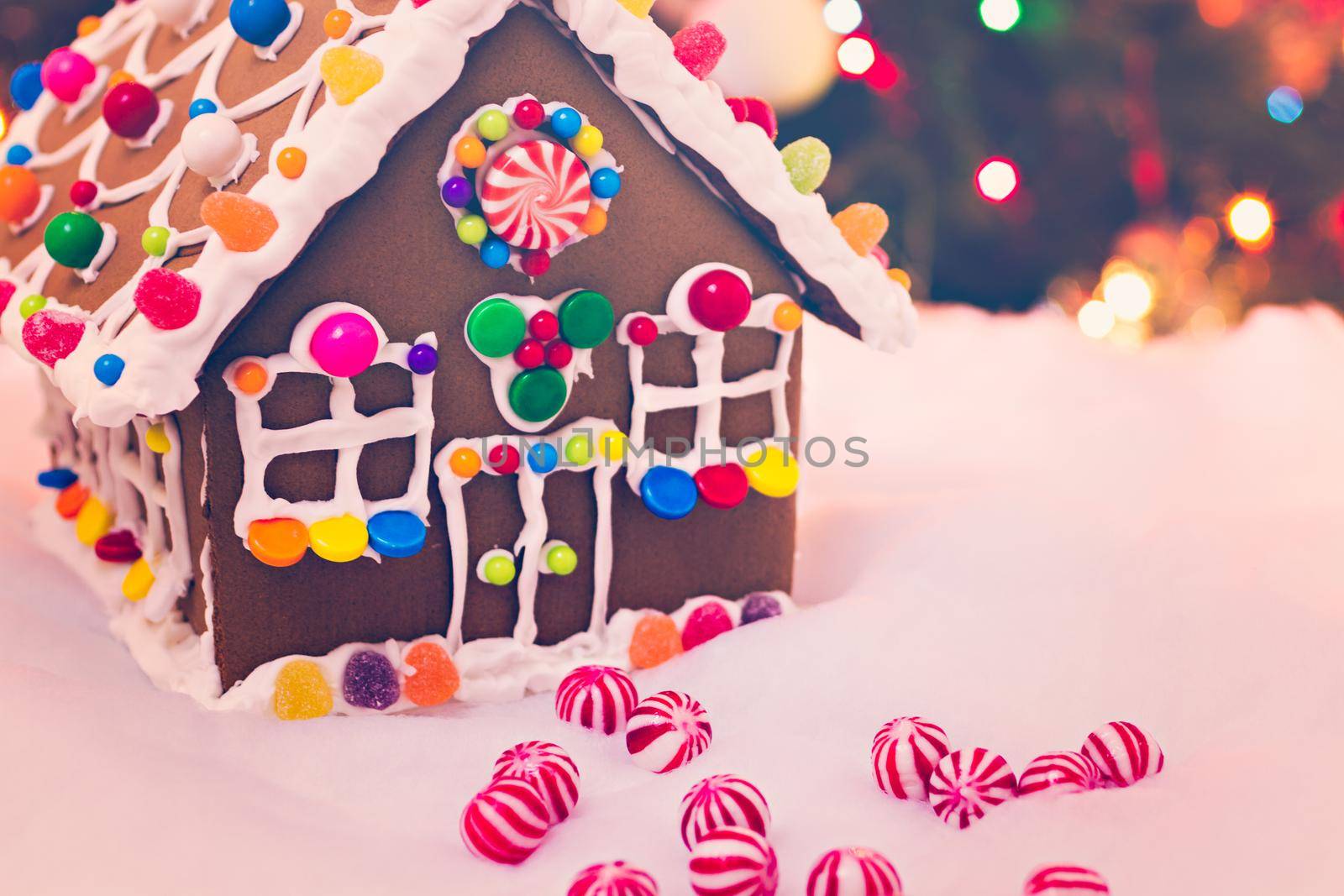 Gingerbread house with round peppermint candies.