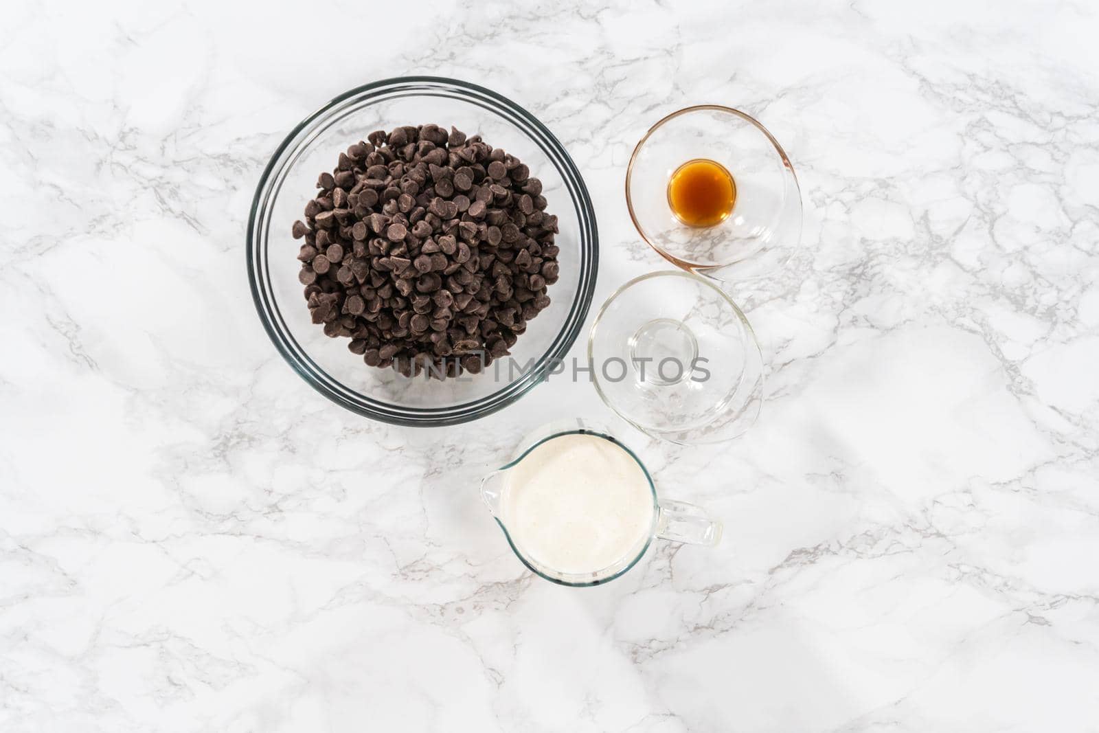 Flat lay. Preparing chocolate ganache in a glass mixing bowl.