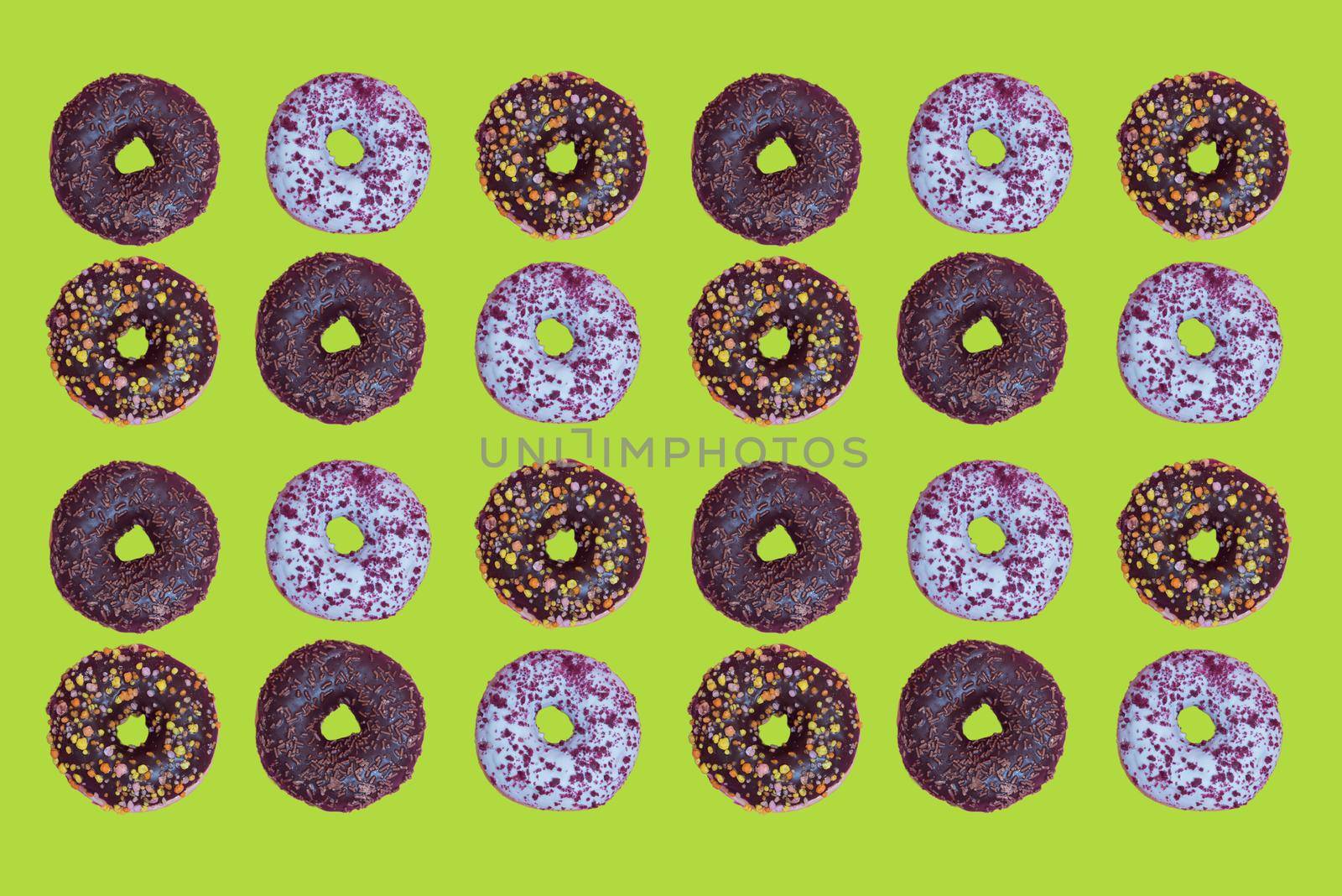 Top view to the donuts over green background