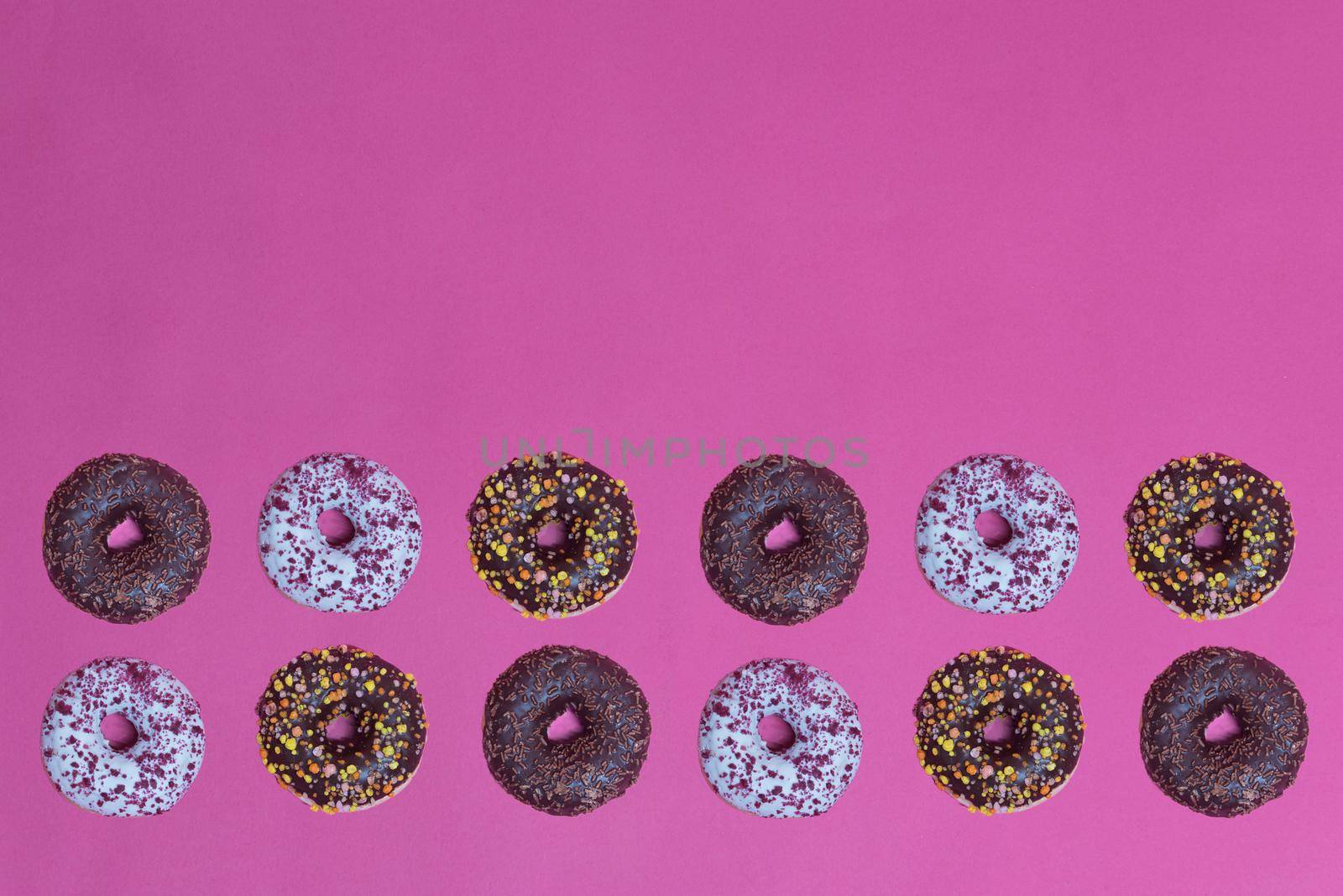 Top view to the donuts over pink by anytka