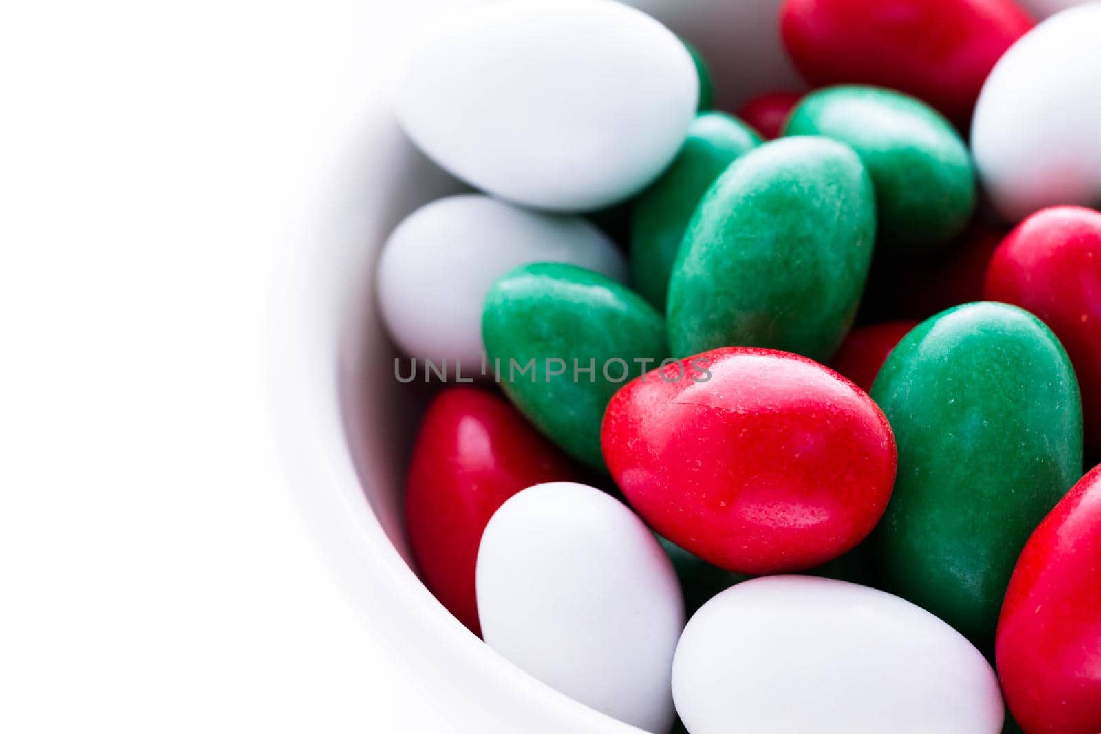 Colorful red, green and white candies on white background.