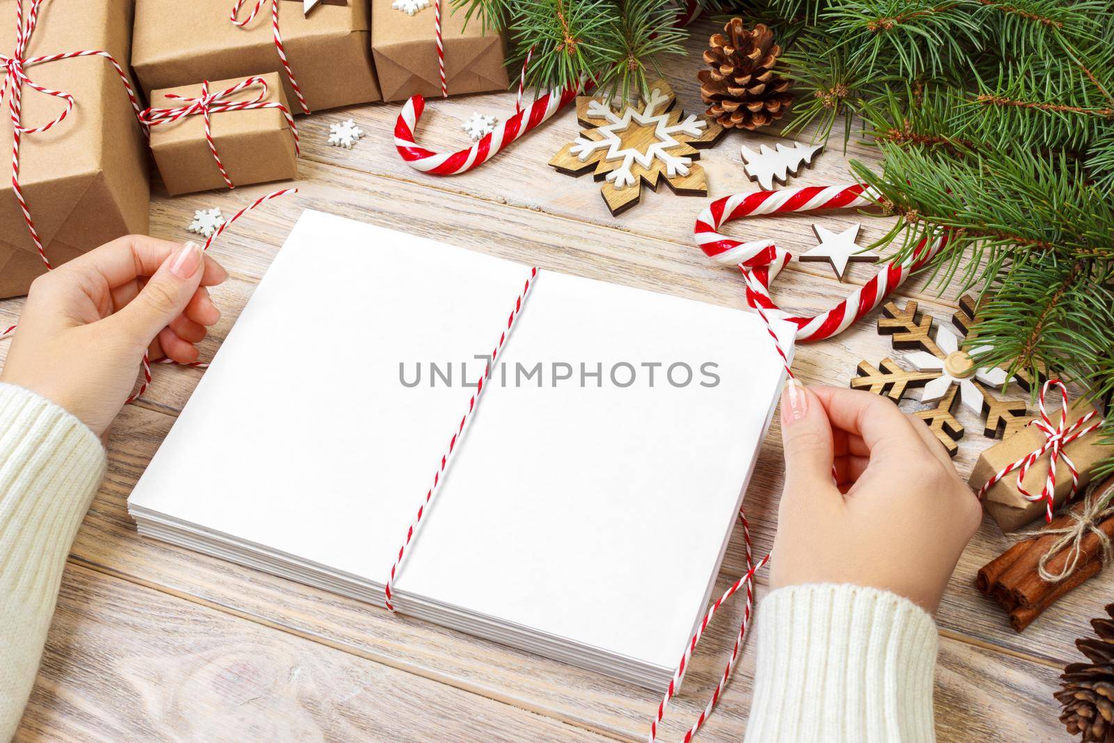 letters wrapping and Gift box, cards for Christmas greetings. Envelopes with letters, gifts, Christmas tree branches and christmas decoration, top view, copy space.