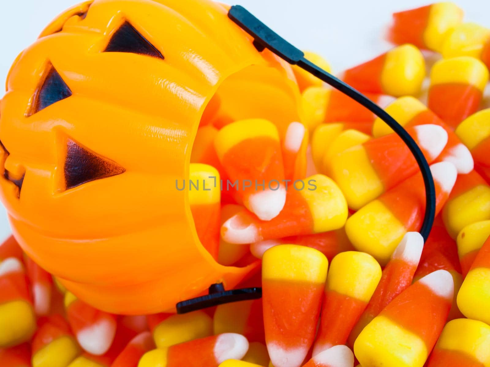 Candy corn candies falling out of Halloween treat bag.