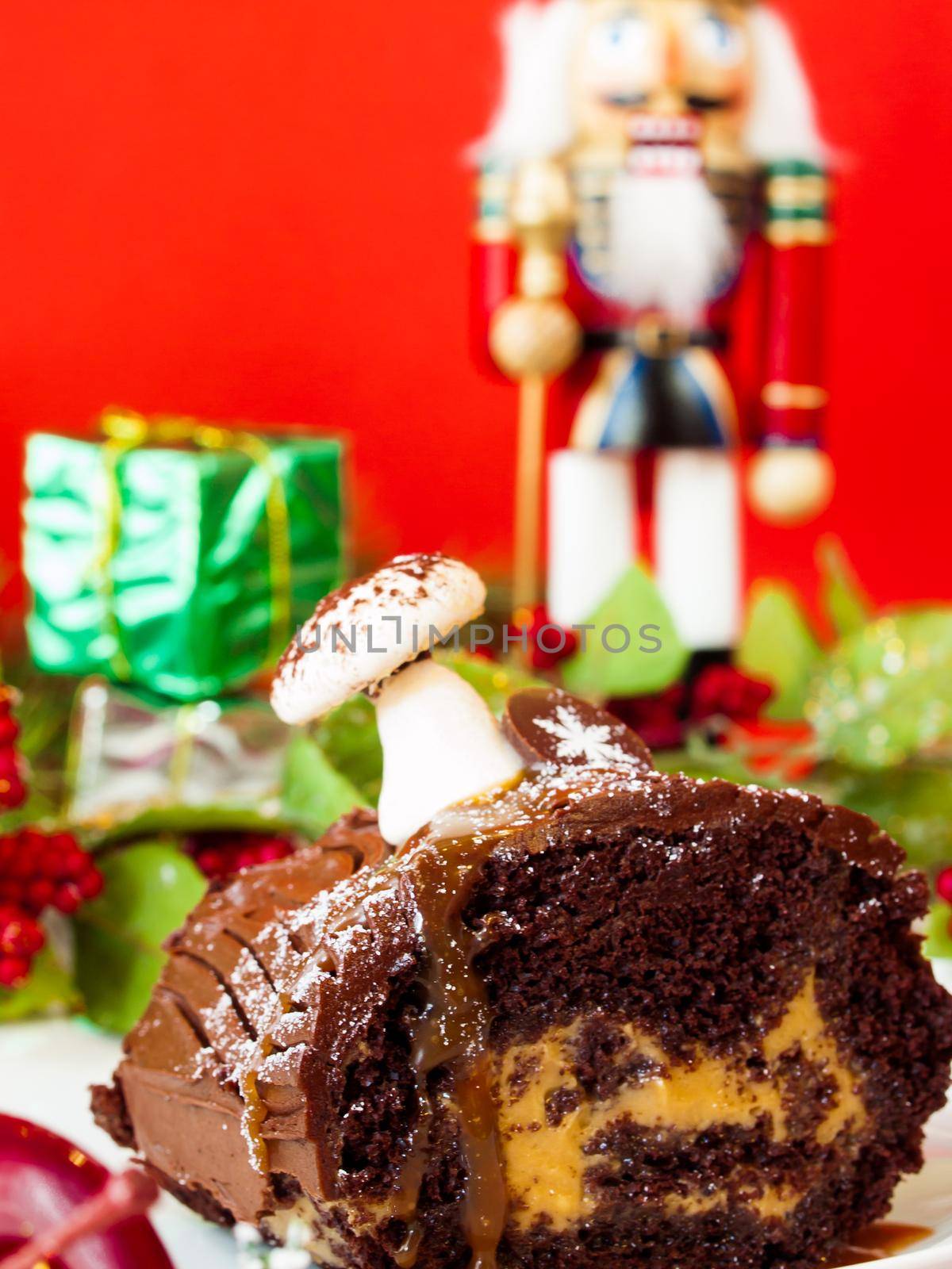 Traditional Christmas Yule Log cake decorated with marzipan mushrooms.