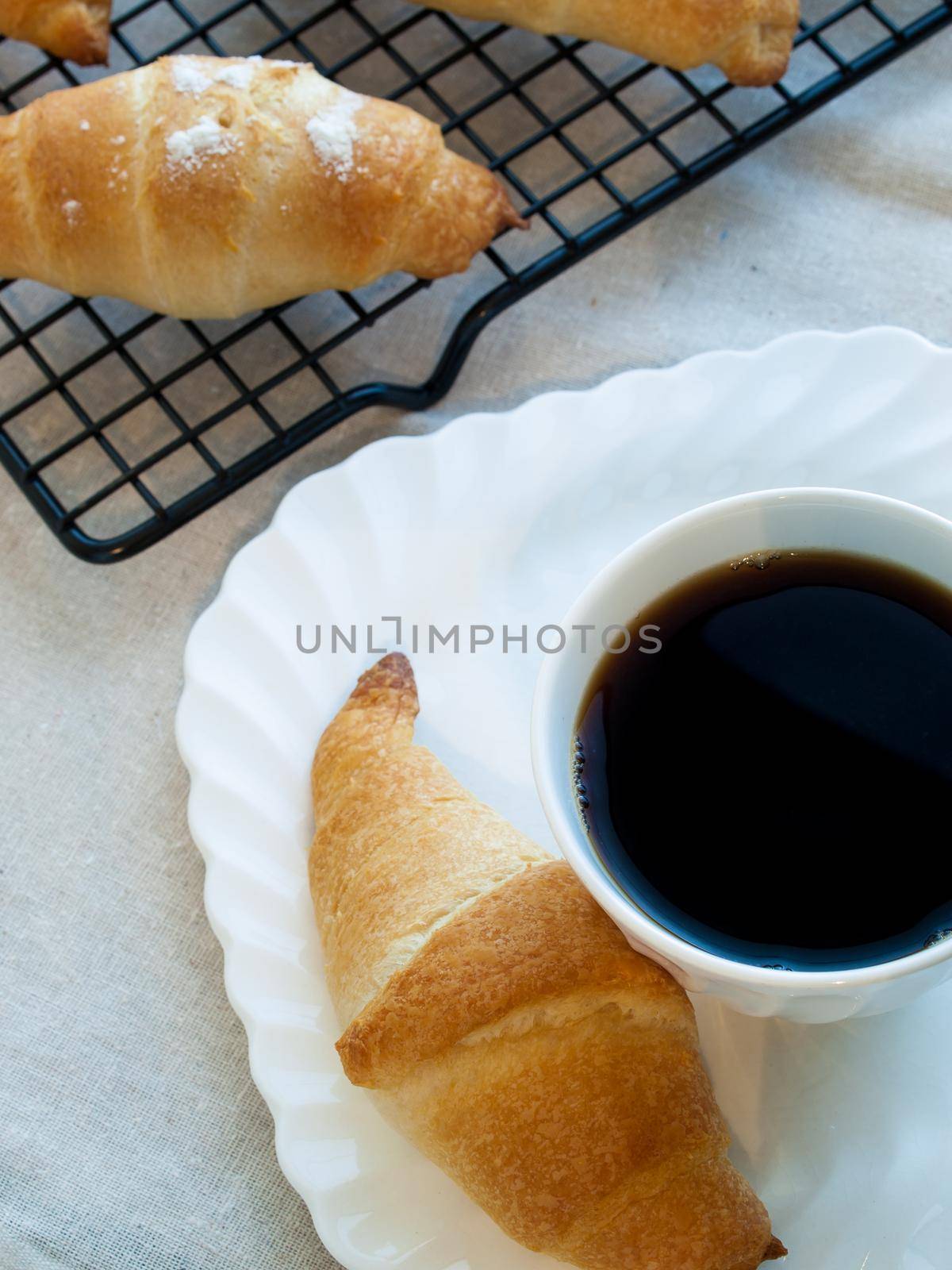 Eating small croissants for breakfast.
