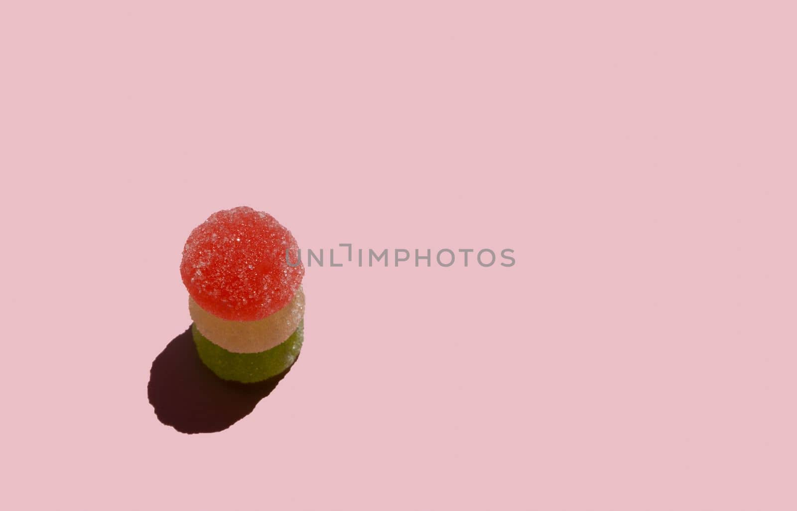Jelly candies on pastel pink background. Color minimalism. Minimal sweets backdrop. Sunny day shadow. by Ri6ka