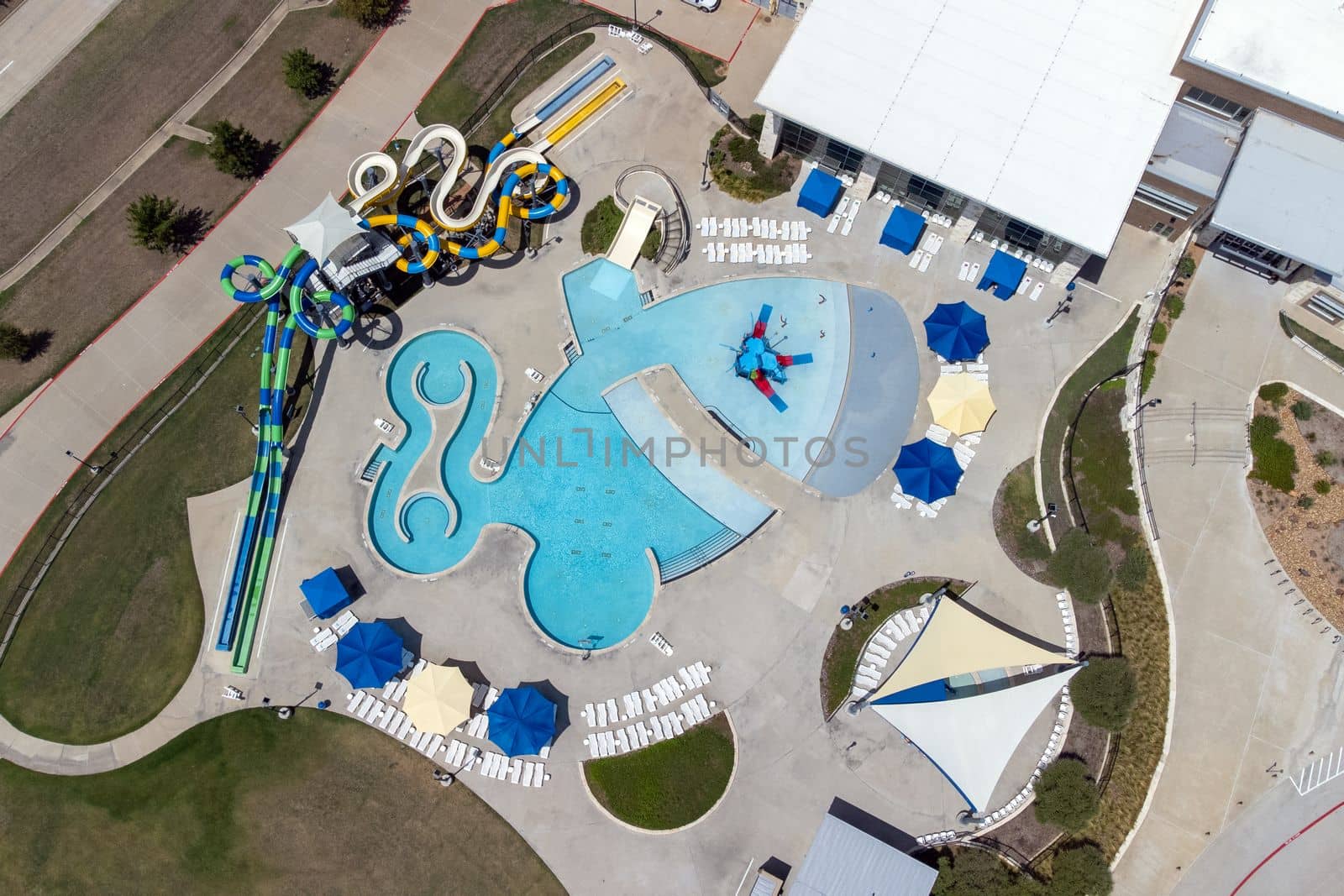 Aerial view from flying drone of aquapark, water park with various water slides, pool, sun loungers. by Khosro1