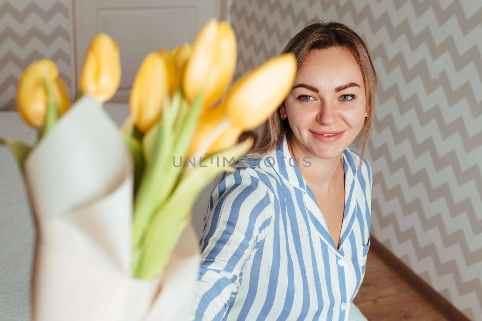 a beautiful woman with a bouquet of tulips. mother's day concept.
