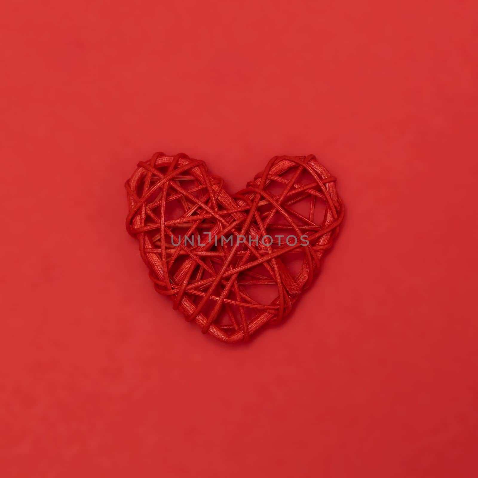 Valentines day red rotang heart on same color background. Monochromatic vivid color. Eco Valentine's day zero waste concept. Close up, copy space. by Ri6ka