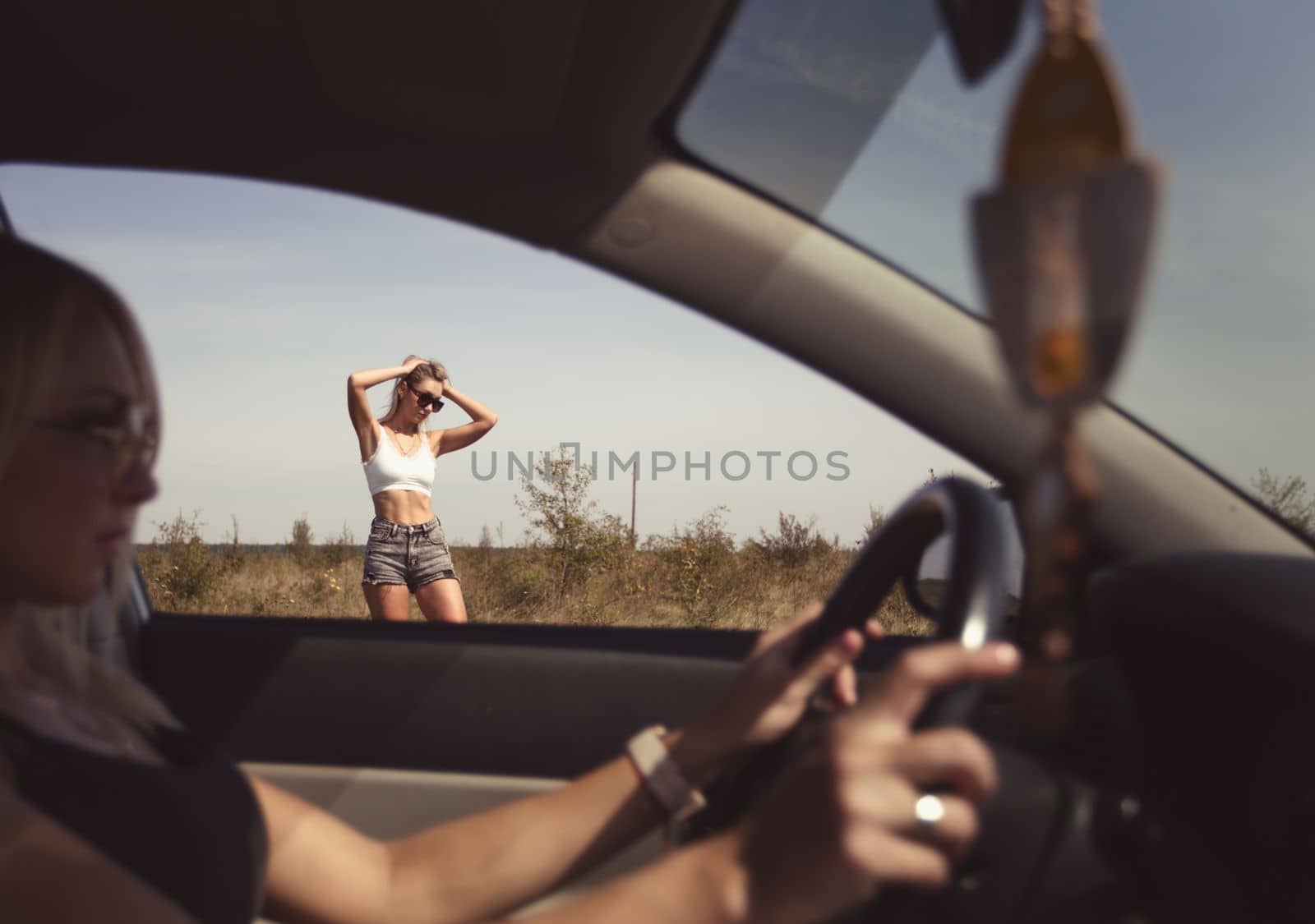 an accident on the road, a car broke down, two beautiful girl models are waiting for help. Car problem. Friends waiting for service. In the countryside skinny. High quality photo