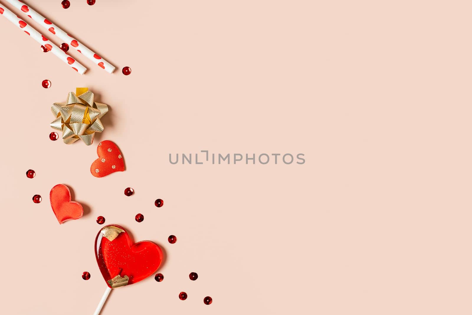 Background with gift, confetti and hearts lollipops with free space for text on pink background. Valentines day concept. Mother's Day concept. Mockup Greetings card. Copy space. Flat lay, top view.