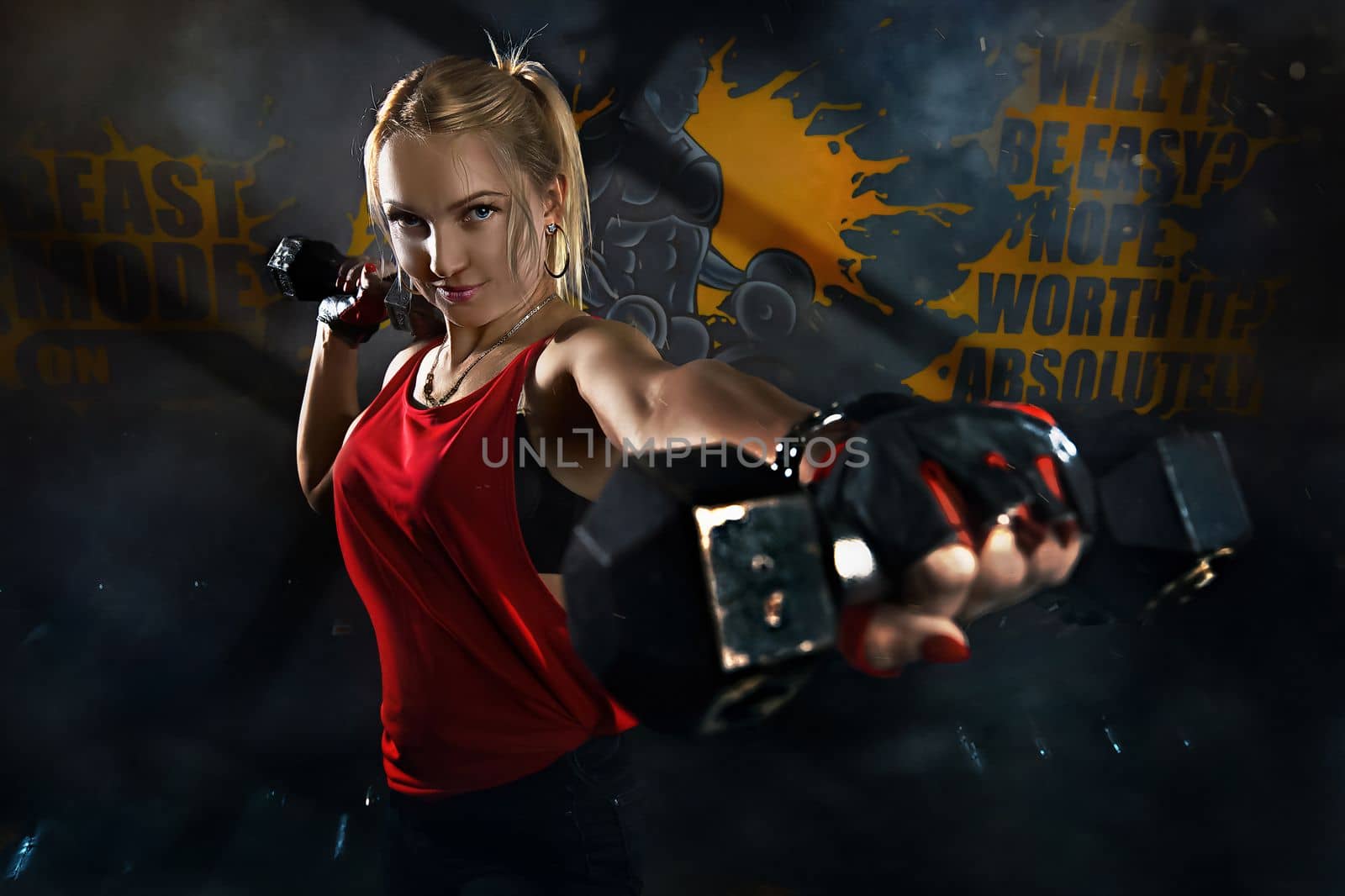 Fitness woman working out in gym doing exercise for biceps. Athletic girl training. Beautiful fitness woman lifting dumbbells . Fitness sporty woman showing her well trained body . A beautiful girl's.