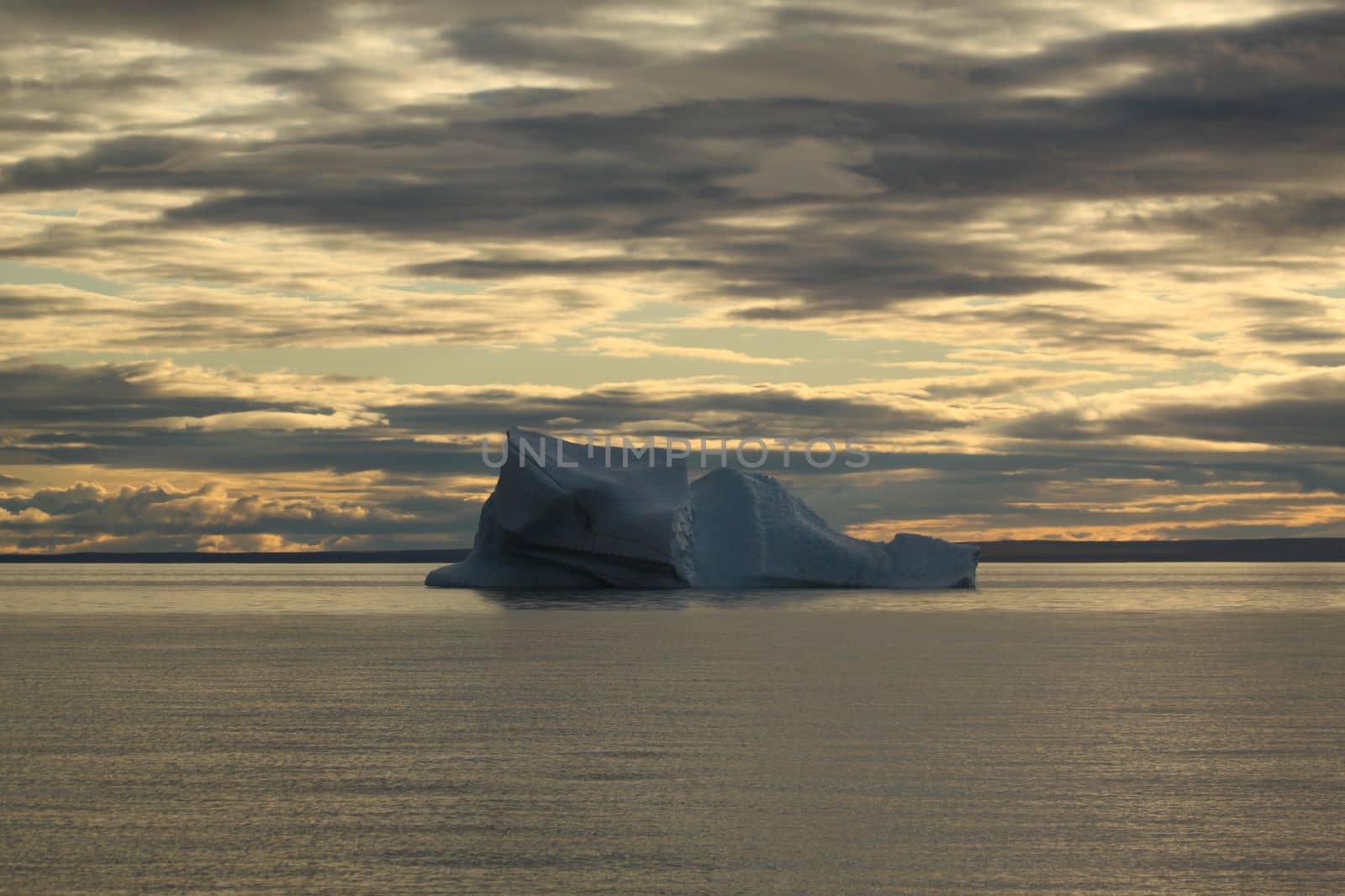 Stranded iceberg and ice near evening in arctic landscape, near Pond Inlet, Nunavut by Granchinho