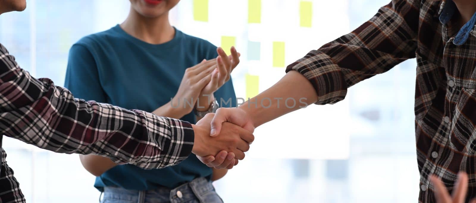 Cropped image business people shaking hands for successful agreement or after meeting in office.