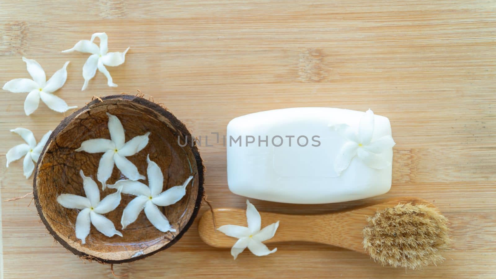 Soap and massage brush decorated with flowers, personal care, background by voktybre