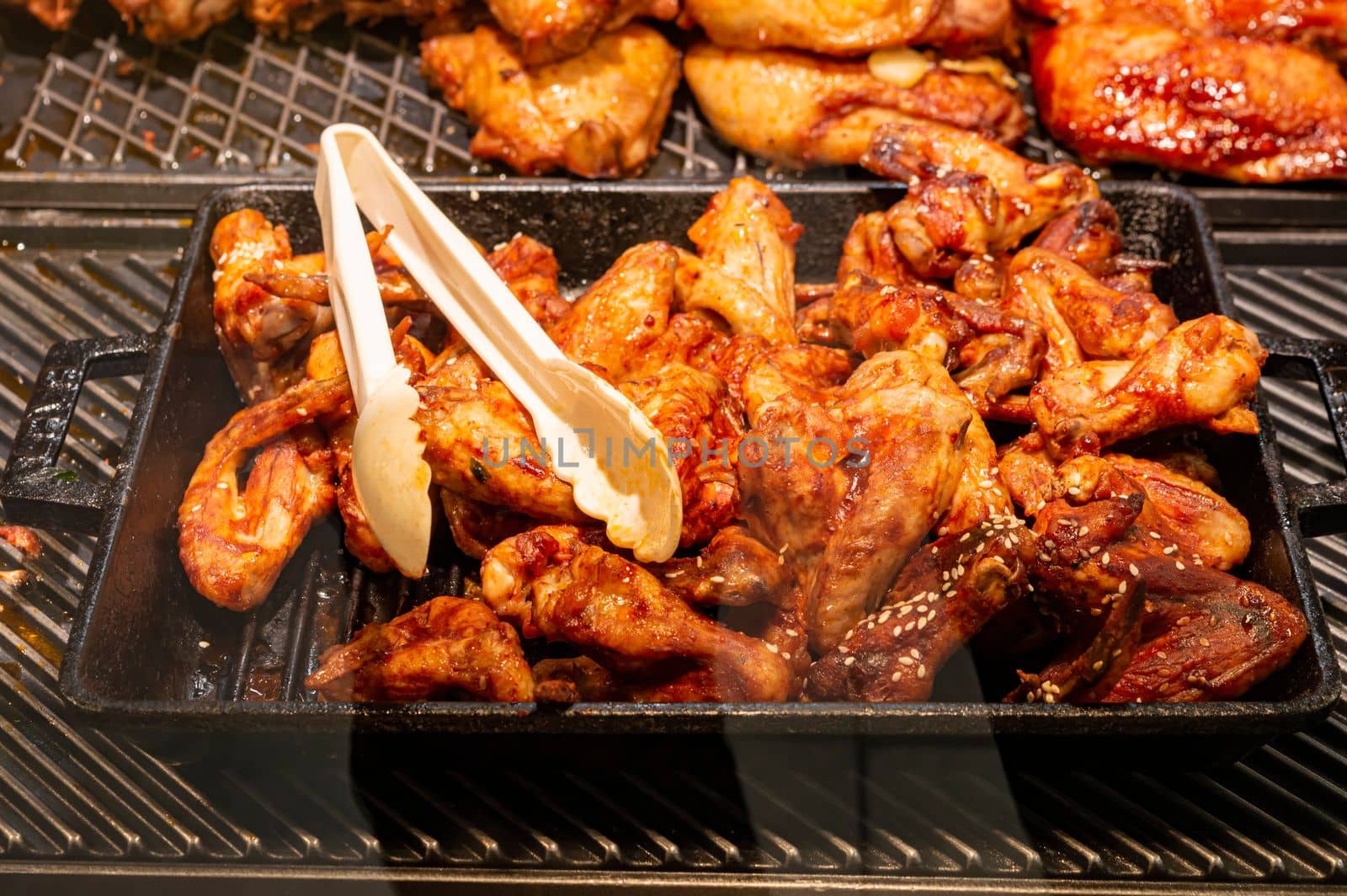 fried chicken wings on the shelves of stores close-up. photo